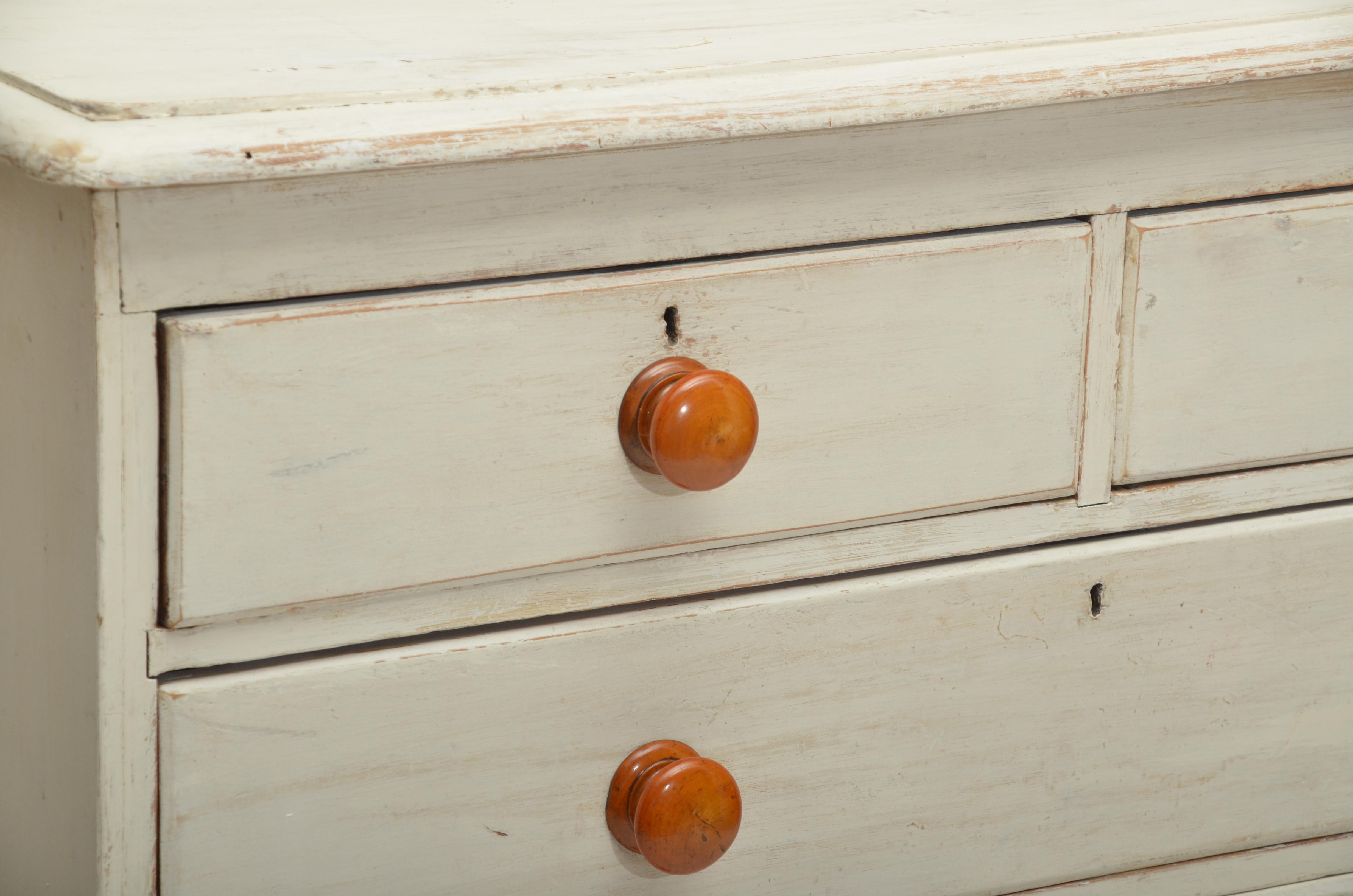 Painted pine chest with two short drawers over three long, original maple knobs.