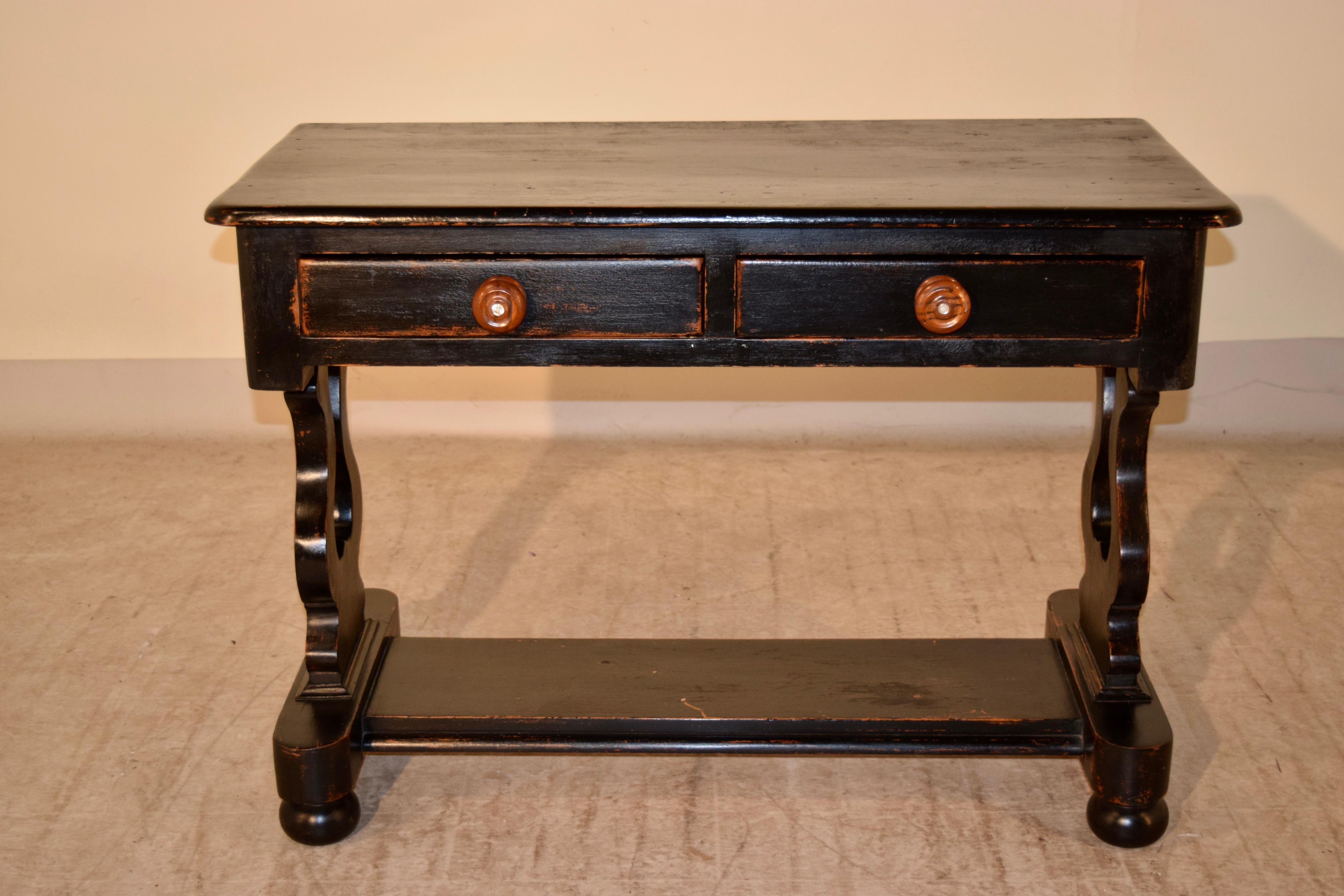 19th century Swedish pine console with two drawers and pierced vase-shaped trestle legs, joined by a bottom shelf. Supported on bun feet.