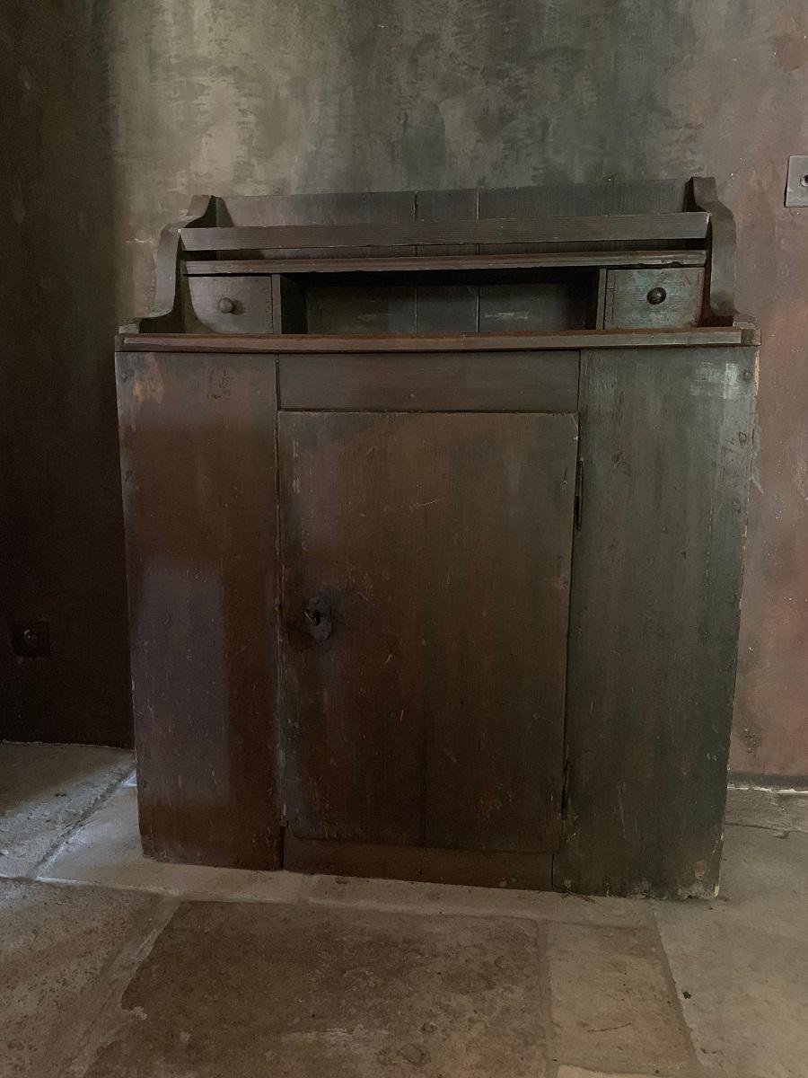 A small 19th century Spanish cupboard in softwood with the original paint. The lower part with one door enclosing one shelf and the upper part with two tops flanked by two small drawers. The whole piece dovetailed with large wide planks.
Lovely and