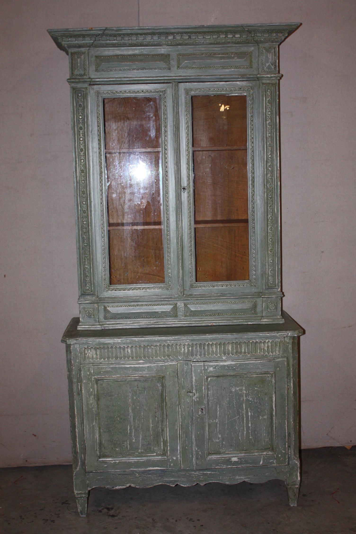 This is a really great looking petite painted buffet deux corps I purchased in France. It dates to the mid-1800s. It is in great shape. The patina of the paint is very nice. The panels of the upper doors are glass.