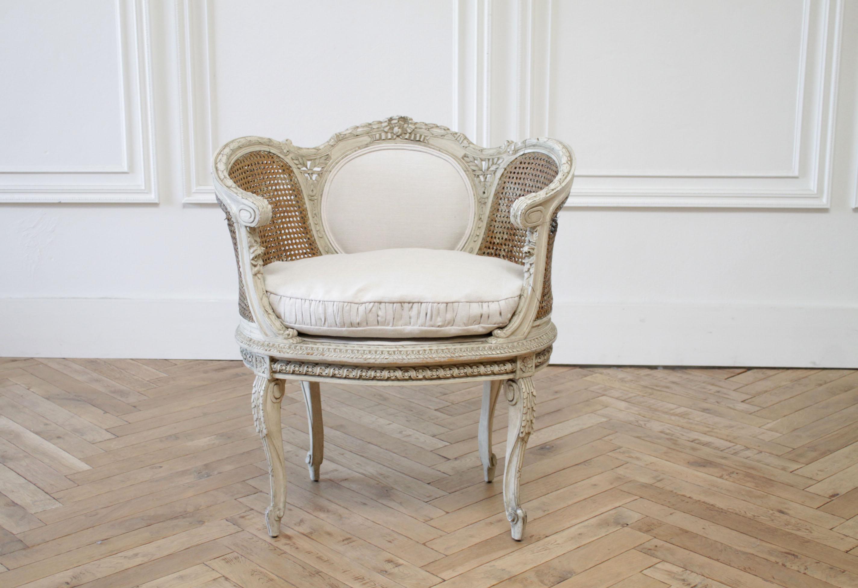 19th century painted French cane chair with linen slip cover cushion
Original painted finish, beautiful antique patina, this 19th century French chair has been reupholstered in our bone linen. The seat cushion is slip covered, with a cinched box to