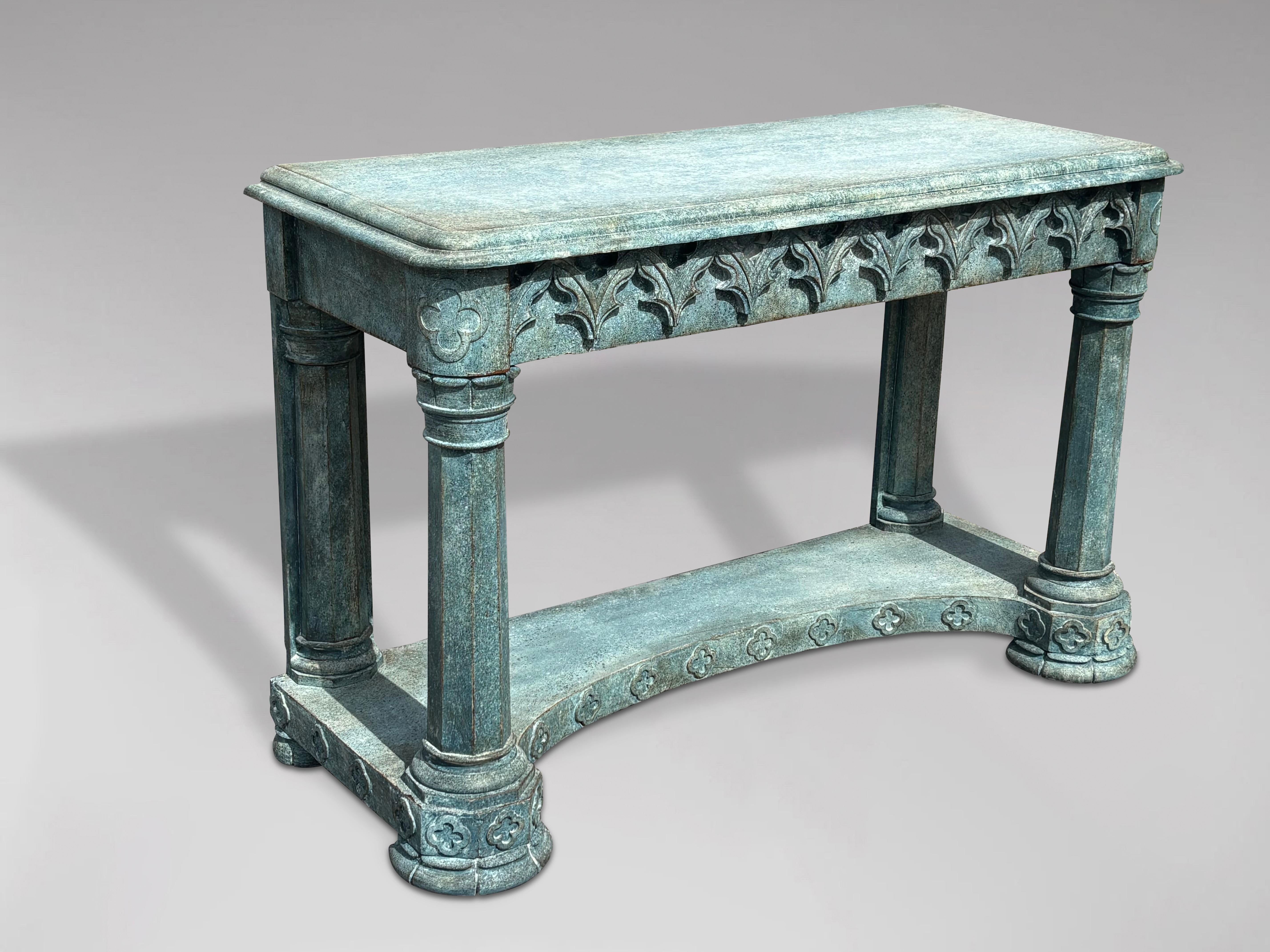 An imposing 19th century painted console table in the Gothic taste. Rectangular moulded rounded top underlined by a succession of broken moulded carved arches evoking gothic architecture with carved rosettes to the corners. Rounded shaped column