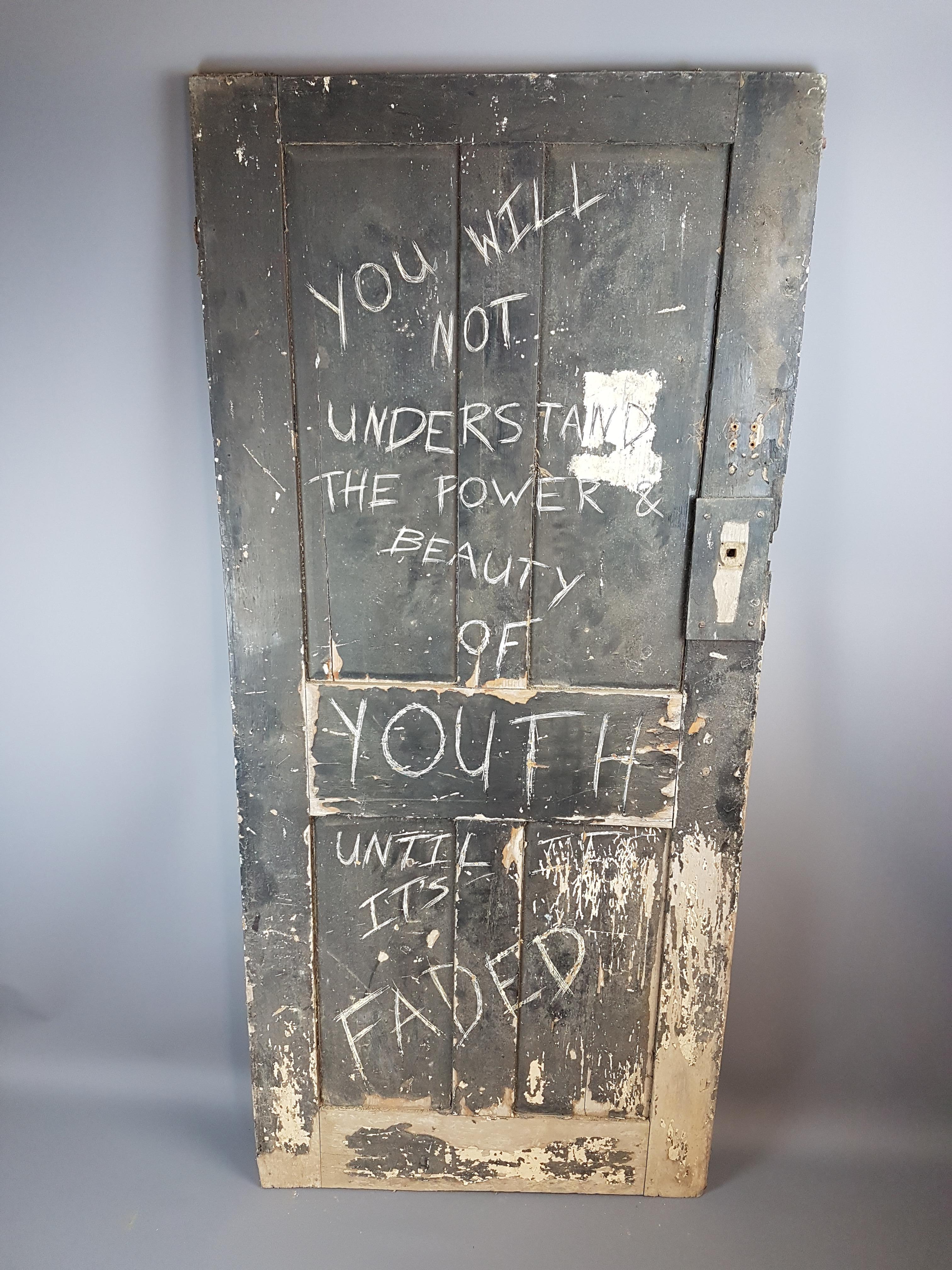 A very cool, decorative, faded and neglected 19th century painted door with later scratched in graffiti art wording. The door was salvaged from an outbuilding of house set for demolition. A very unique decorative wall art item which would look great