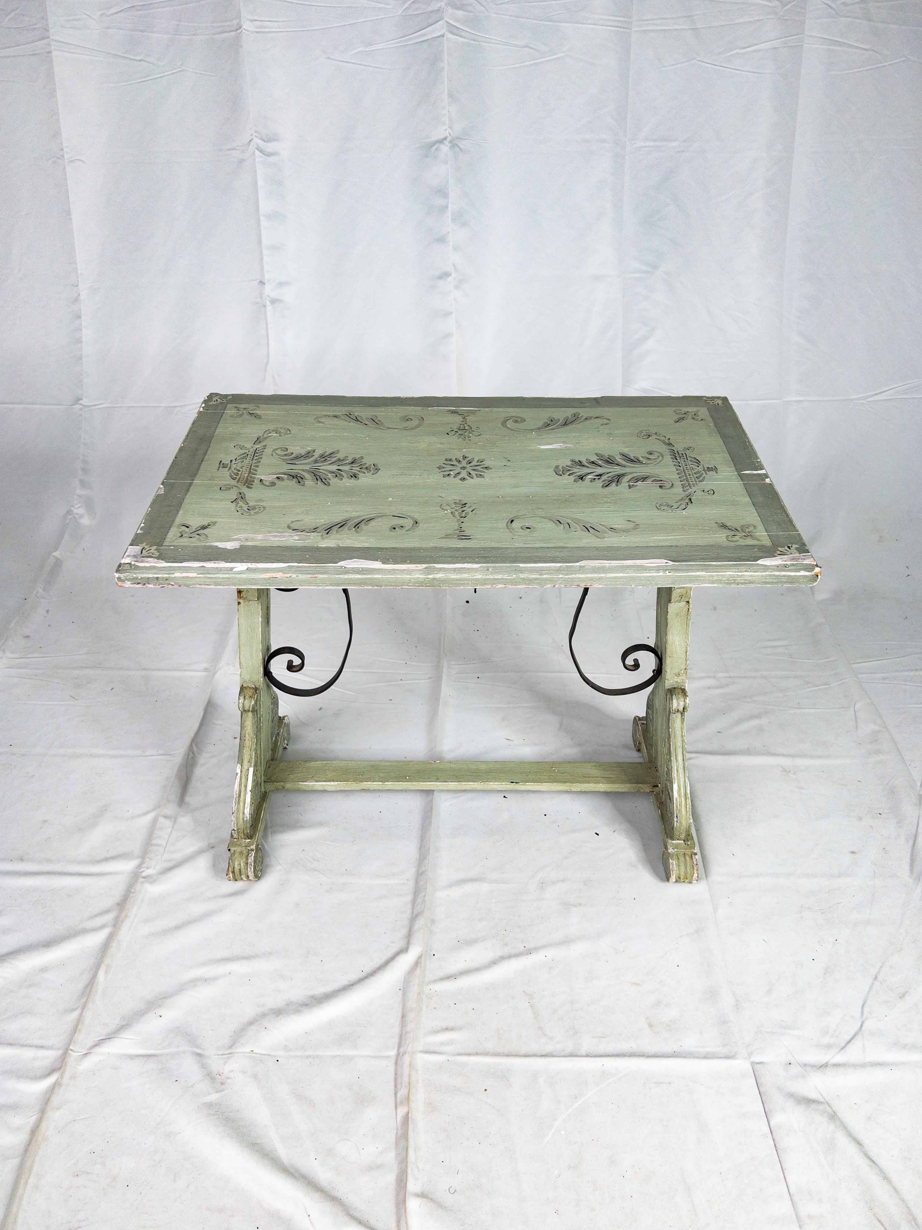 19th Century Painted Italian Side Trestle Table
The 19th Century Painted Italian Side Trestle Table is a captivating fusion of artistry and functionality. Its painted surface exudes a vintage charm, with intricate ironwork embellishments adorning