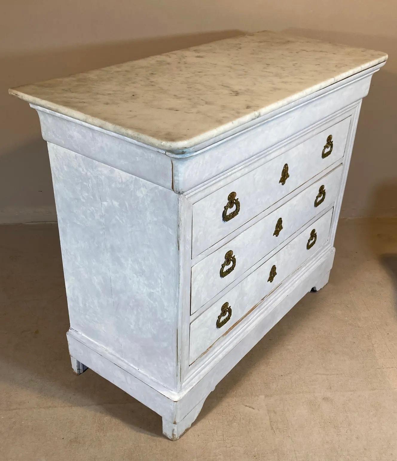 A period Italian commode in the Louis Philippe manner, from about 1830, with its original marble top. The custom painted finish, with its scumbled Swedishy effect, makes for a nice change - it lightens the look. The wonderfully detailed gilded
