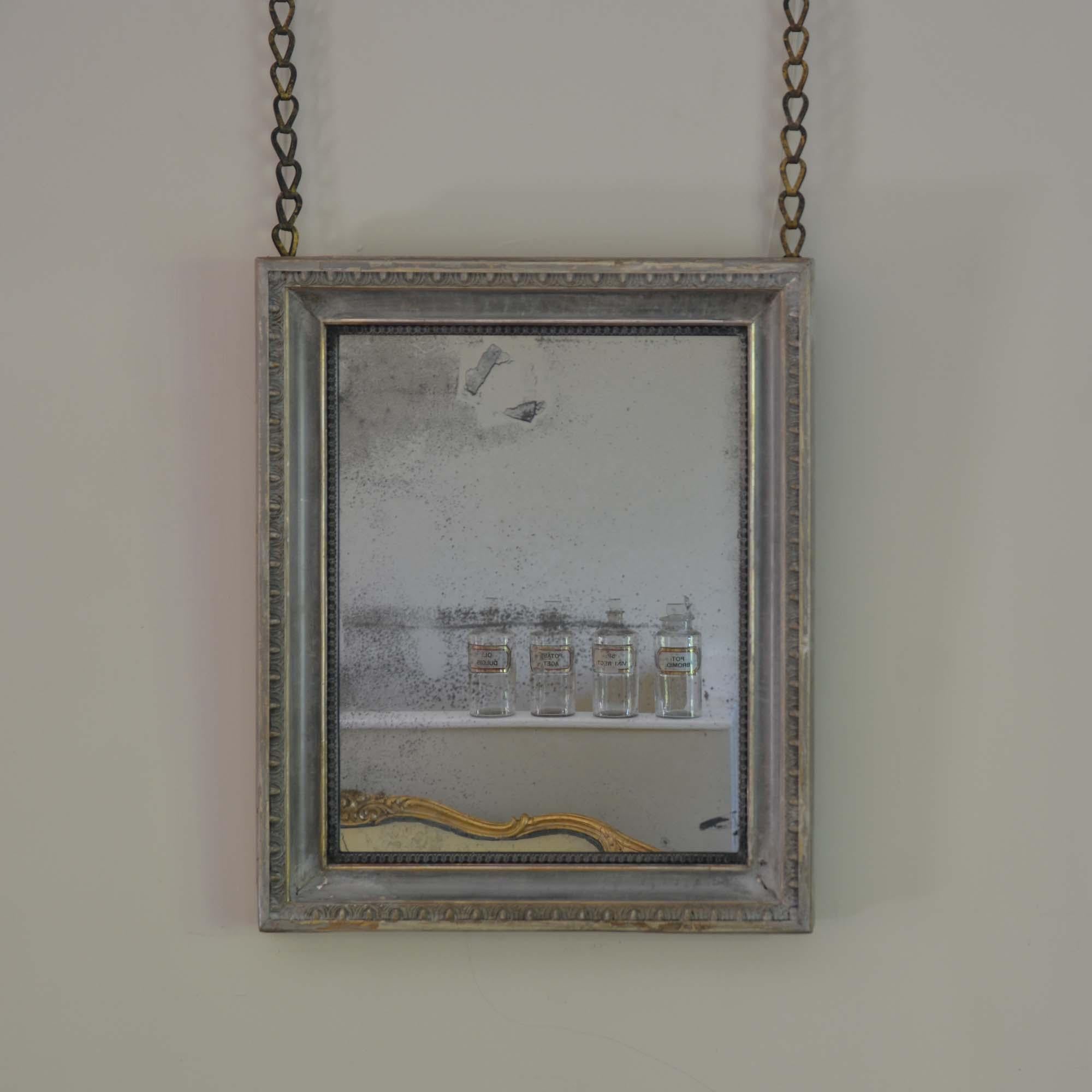 19th century painted mirror
A blue painted gilded frame with egg and dart moulding, the layers of time showing highlights of the original gilding through the paint.   With a heavy mercury mirror plate with some foxing, the panelled back with