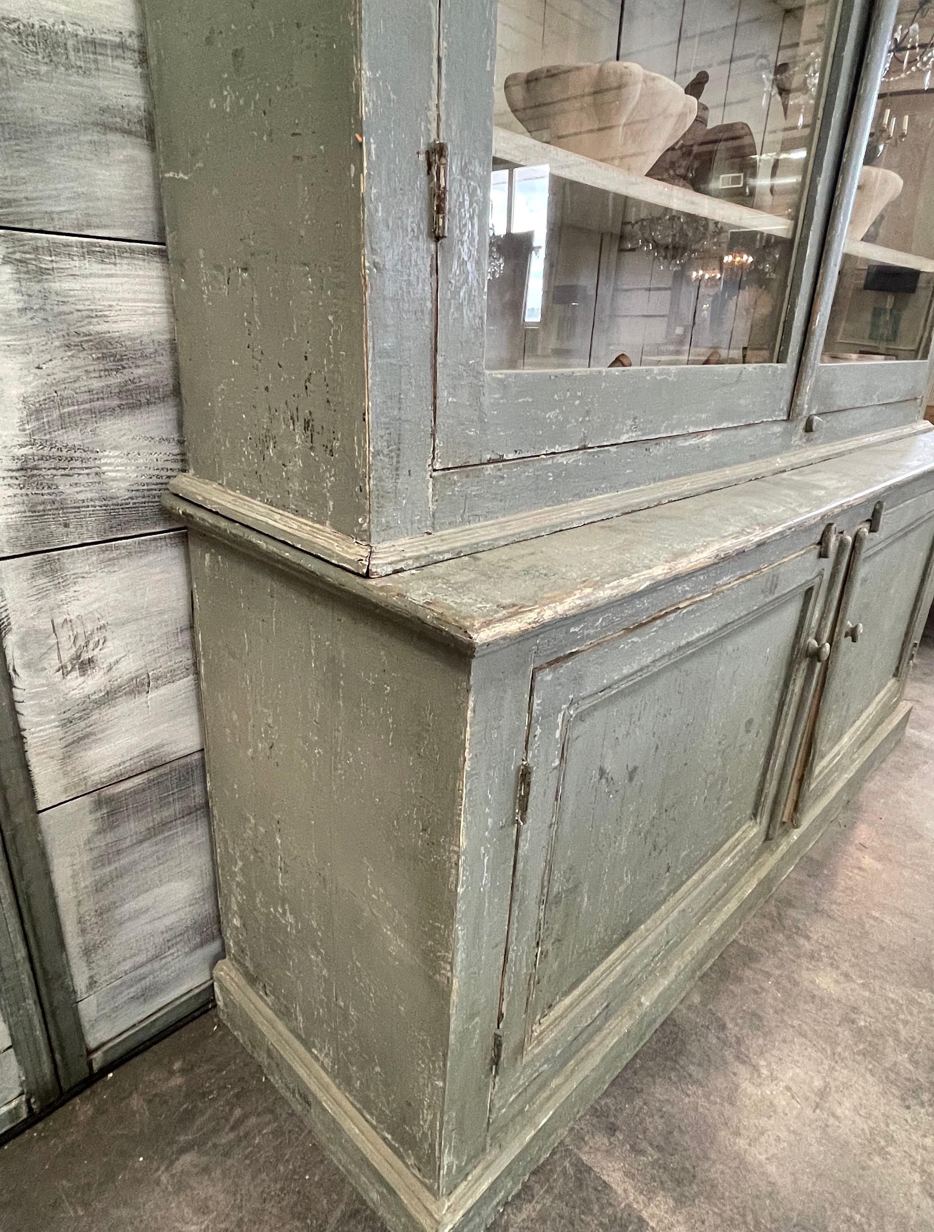 This is a beautiful sage green Pharmacy cabinet from the 19th c that has completely repainted to this beautiful color over its original dark reddish brown. It’s originally from Portugal and has simple clean lines. The crown does have some damage
