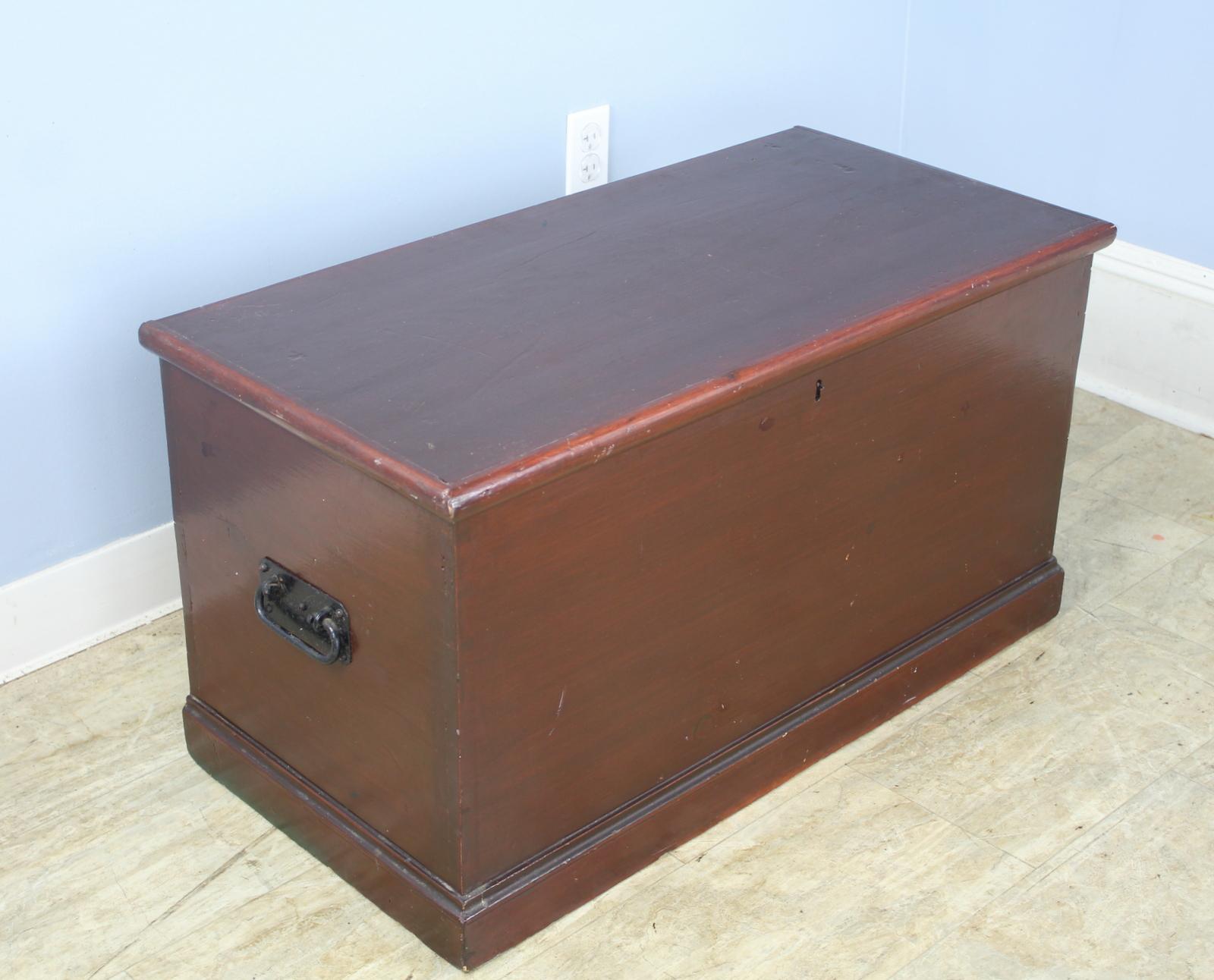 A pine blanket box, painted deep red, with cast iron drop handles to each side and a small internal utility section with its own lid. The interior of this piece is very clean and the overall condition is good. Perfect for the end of the bed or as a