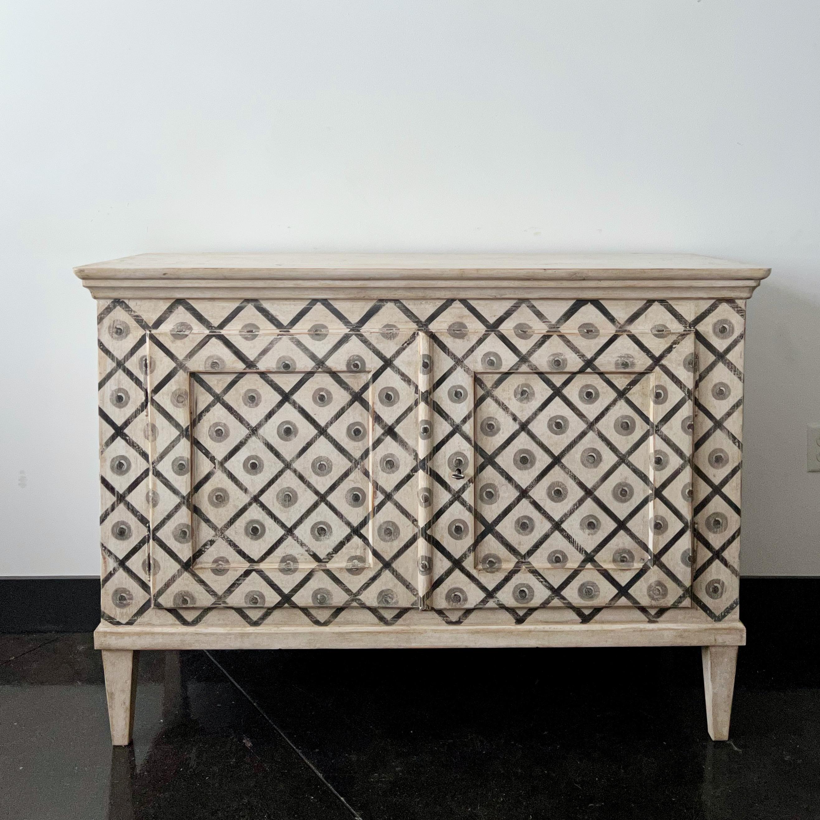 19th century, Louis XVI style two paneled door sideboard in later whimsical refinish diamond-shaped painting with dot decoration on a gray background on tapered feet.
 
