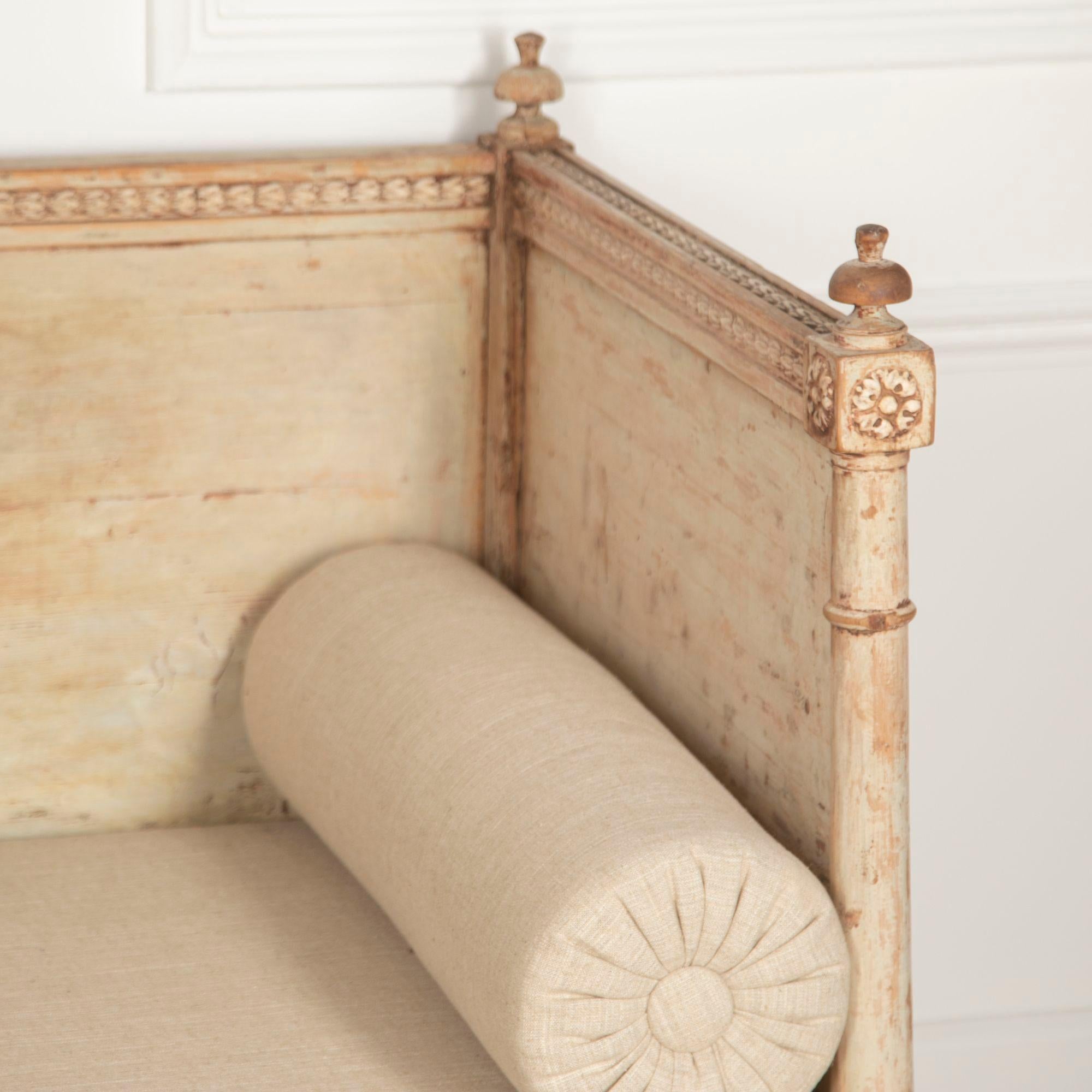 A 19th Century Swedish bench from the Empire period, the back panel decorated with a classical scene of a pair of griffon.
New seat cushion in plain linen.