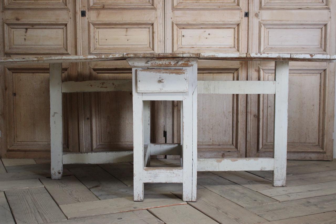 A very charming and with good proportions, mid-19th century Swedish gate-leg dining table that will seat six to eight people. One of the leaves less distressed than the other as it was put against the wall.