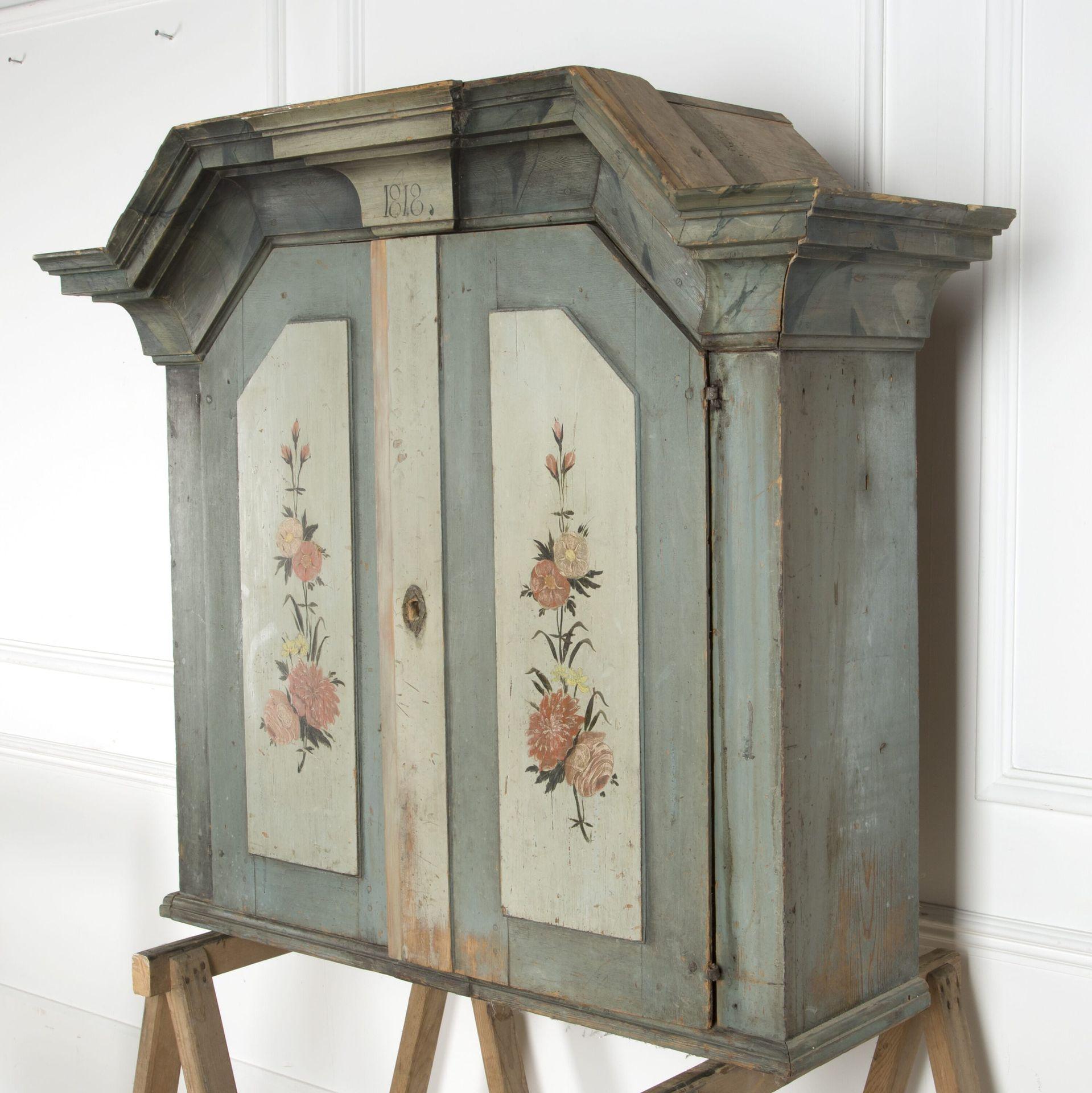 19th century Swedish painted wall cupboard with two doors and shelves.

Dated 1818.