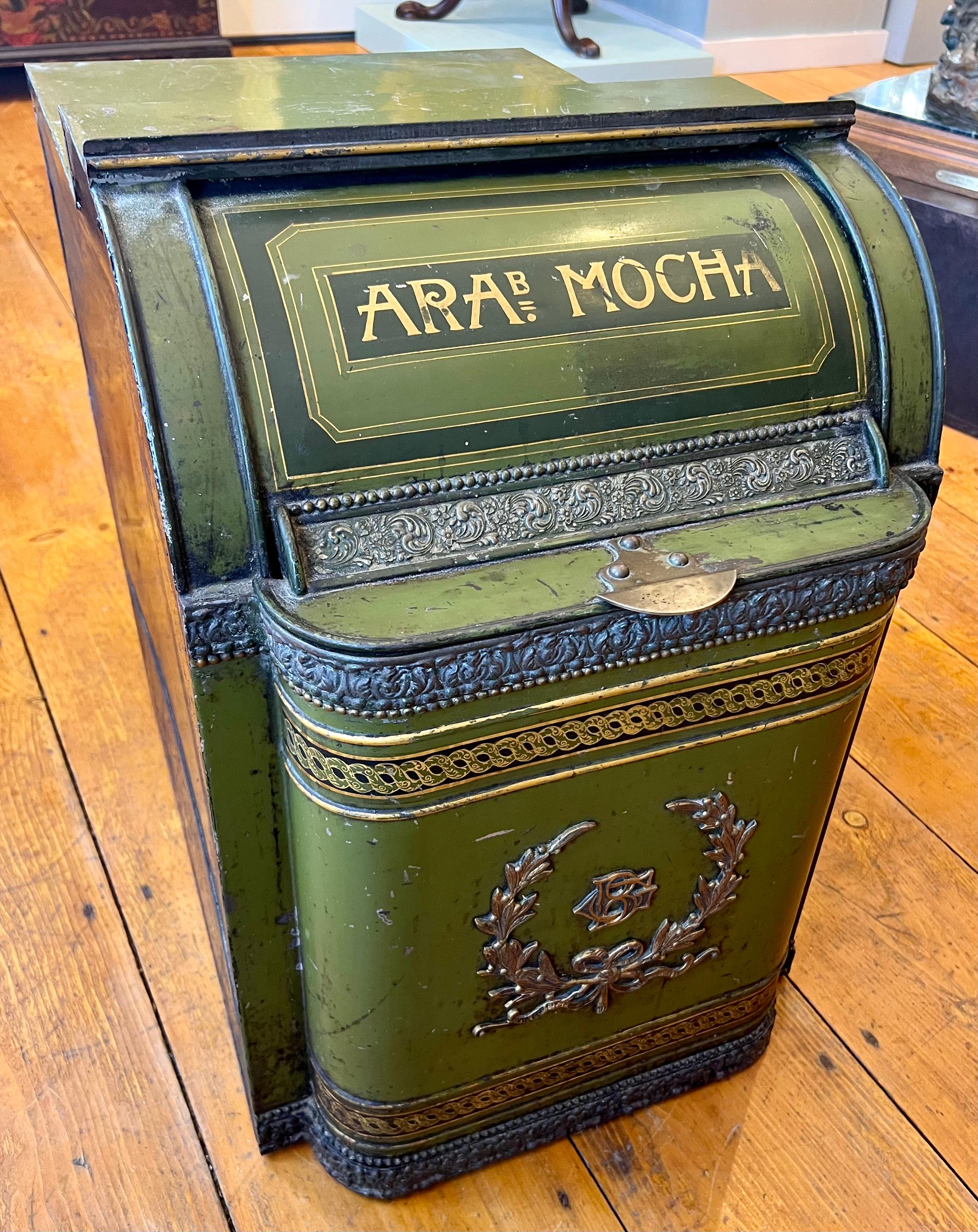 Amazing size and green color coffee bin from the 19th century. Features gilt scroll metal accents and initials lower center with the words Arabian Mocha hand painted on the front. The bin is in overall good condition with some scrapes as would be