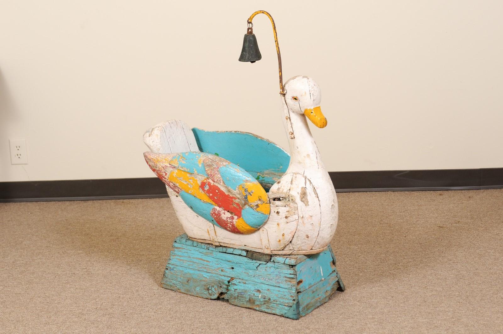 Whimsical 19th century Continental painted and carved wood swan form carousel seat with bell.
 