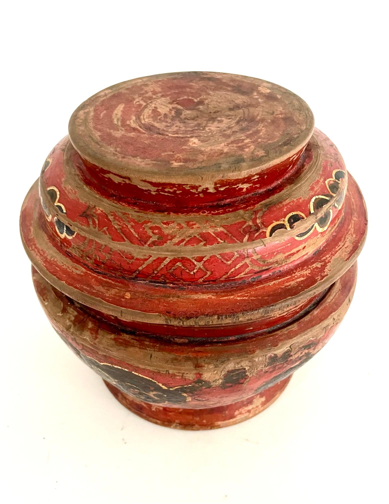 A beautiful late 19th century paint bowl with a lid that was once used for storing the famous Tibetan barley flour (Tsampa). These bowls were used by the Buddhist mountain people of the Himalayas. This fine bowl is hand carved out of hardwood and is