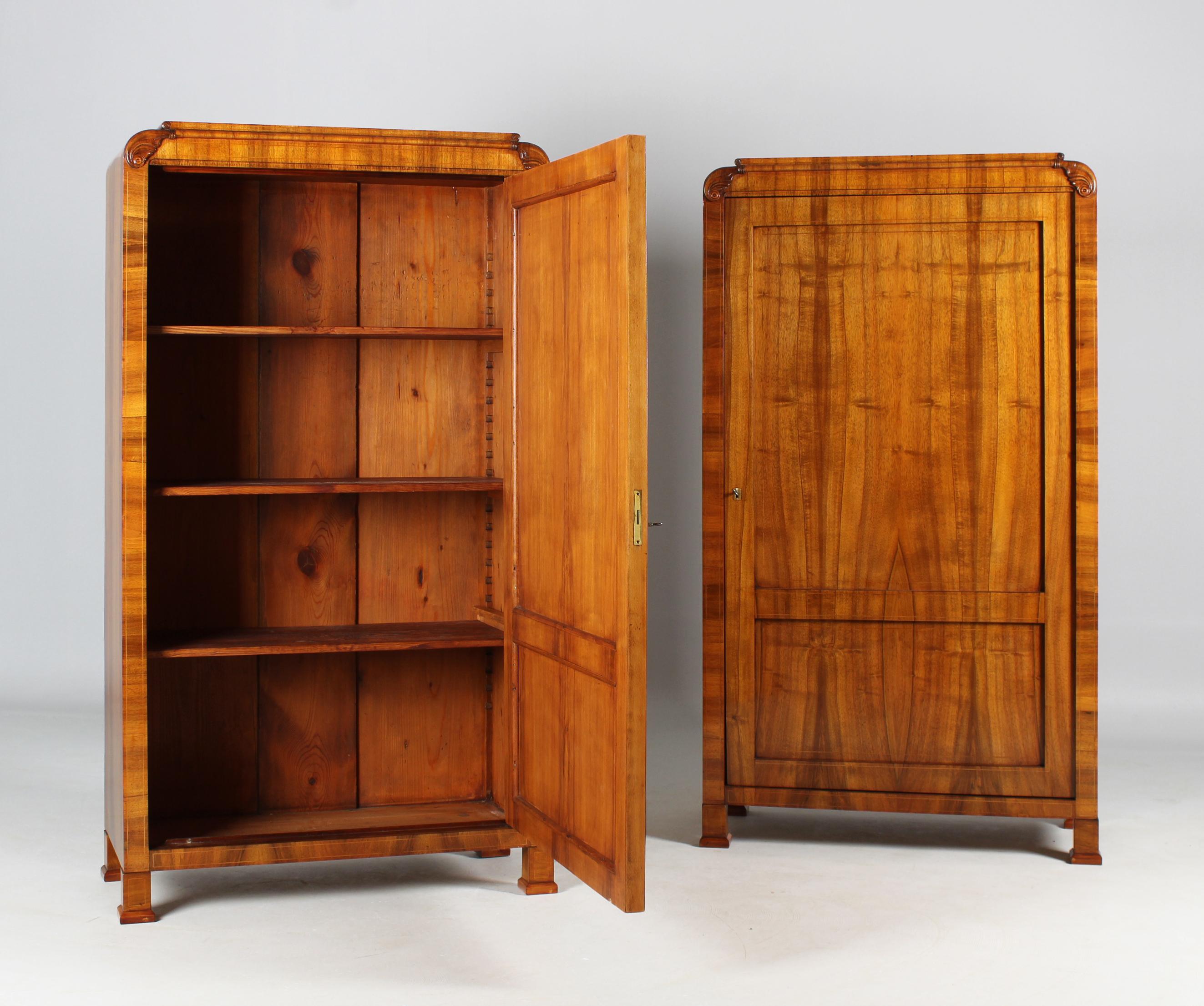 Two identical antique Biedermeier cupboards.

Prague
Walnut
Biedermeier circa 1830

Dimensions: each H x W x D: 168cm x 94cm x 45 cm.

Description:
Two identical cabinets worked as a pair from the Bohemian Biedermeier period circa