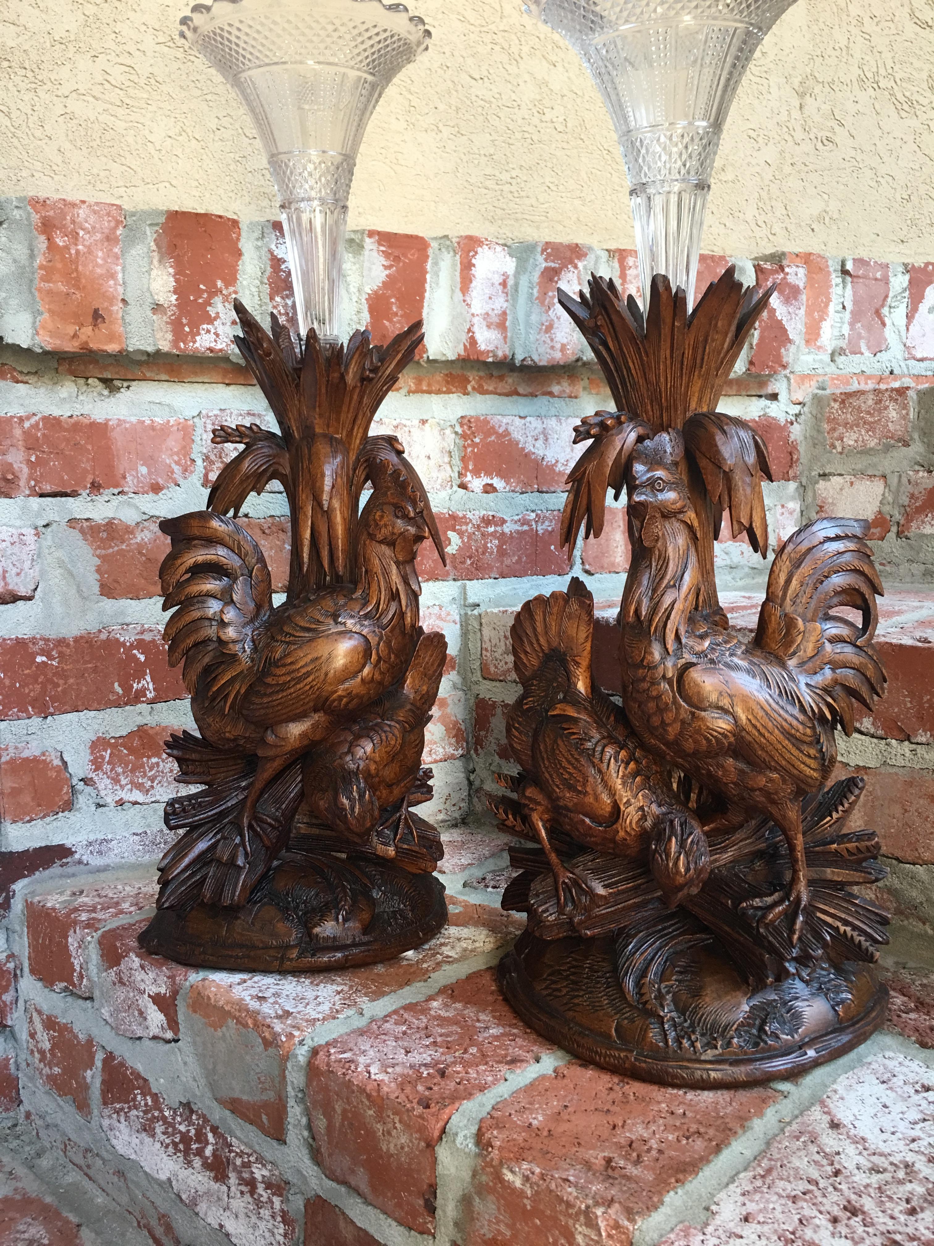 ~ Direct from Europe
This listing is for a stunning pair of carved Black Forest “chicken” candleholders/epergnes. In the summer, the glass inserts were used and fresh cut flowers were arranged in the holders; in the winter the glass was removed and