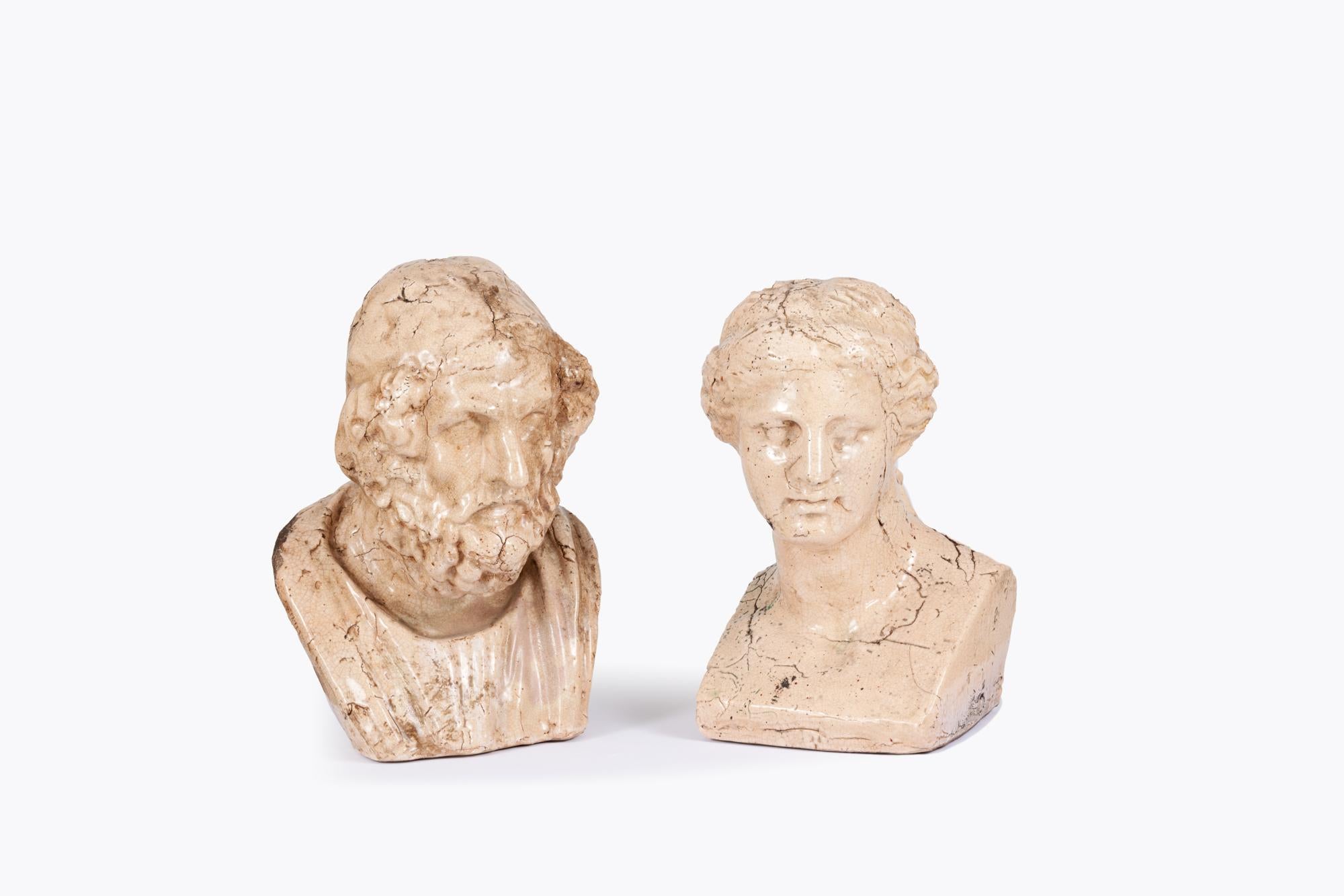19th Century Pair Ceramic Busts depicting the Greek figures Aphrodite and Homer, both giving the illusion of aged stone.

The bust of Homer is based on a much-restored Roman copy of a Hellenistic original. It depicts the poet as a mature bearded