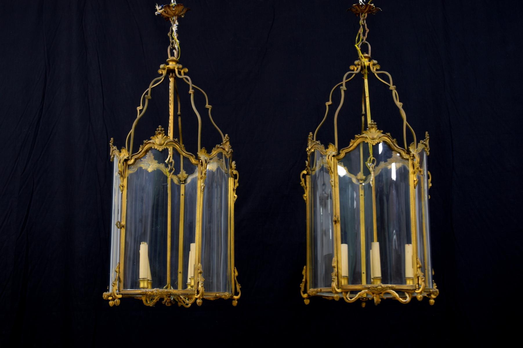 Pair of French gilt bronze and shaped glass lanterns with four lights
End of 19th century. Louis XV style.

The pair of lanterns was made at the end of the 19th century in Louis XV style, French. They have a round shape in bronze finely chiselled