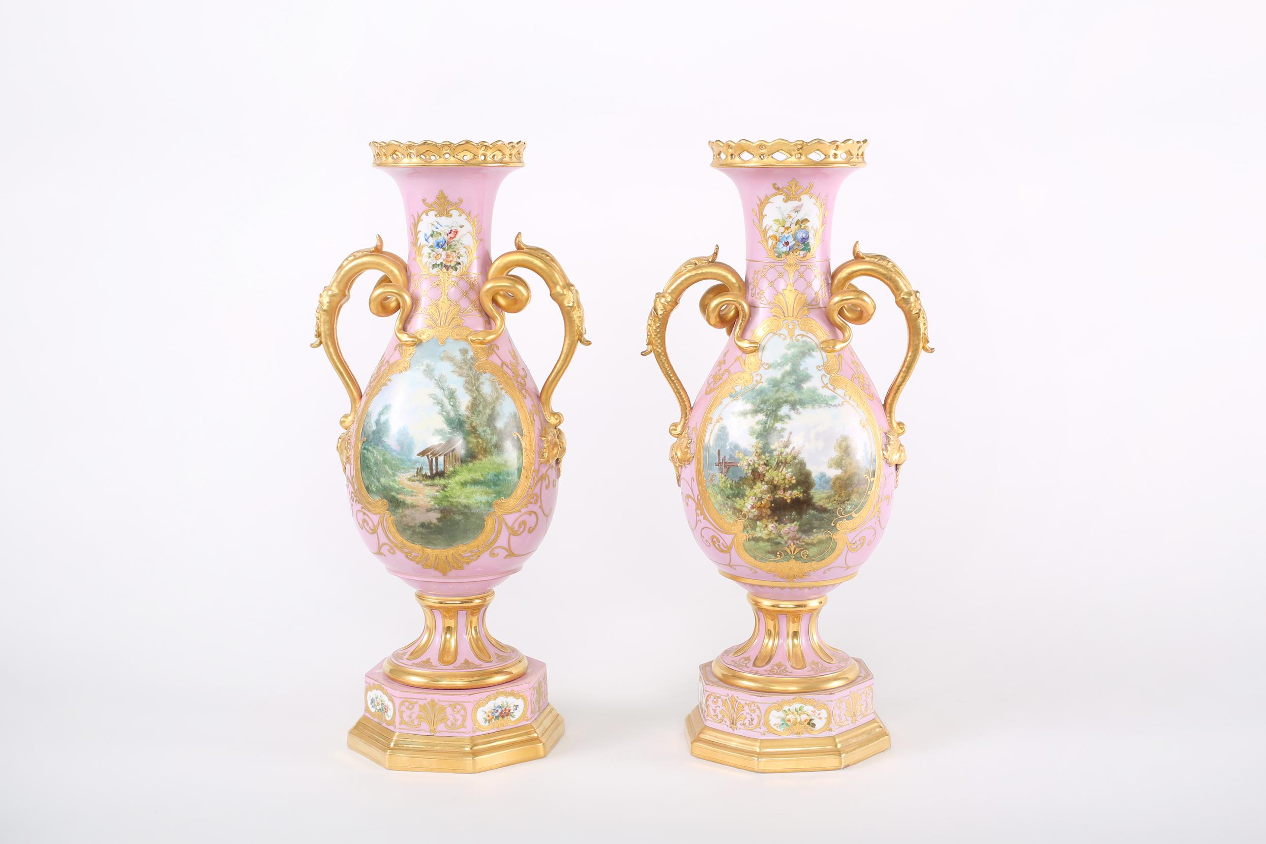 Early 19th century pair gilt porcelain decorative urns / vases with gilt gold handles and exterior painted scene details. Each vase / urn is in great antique condition. Minor wear consistent with age / use. Numbered & Maker's mark undersigned. Each