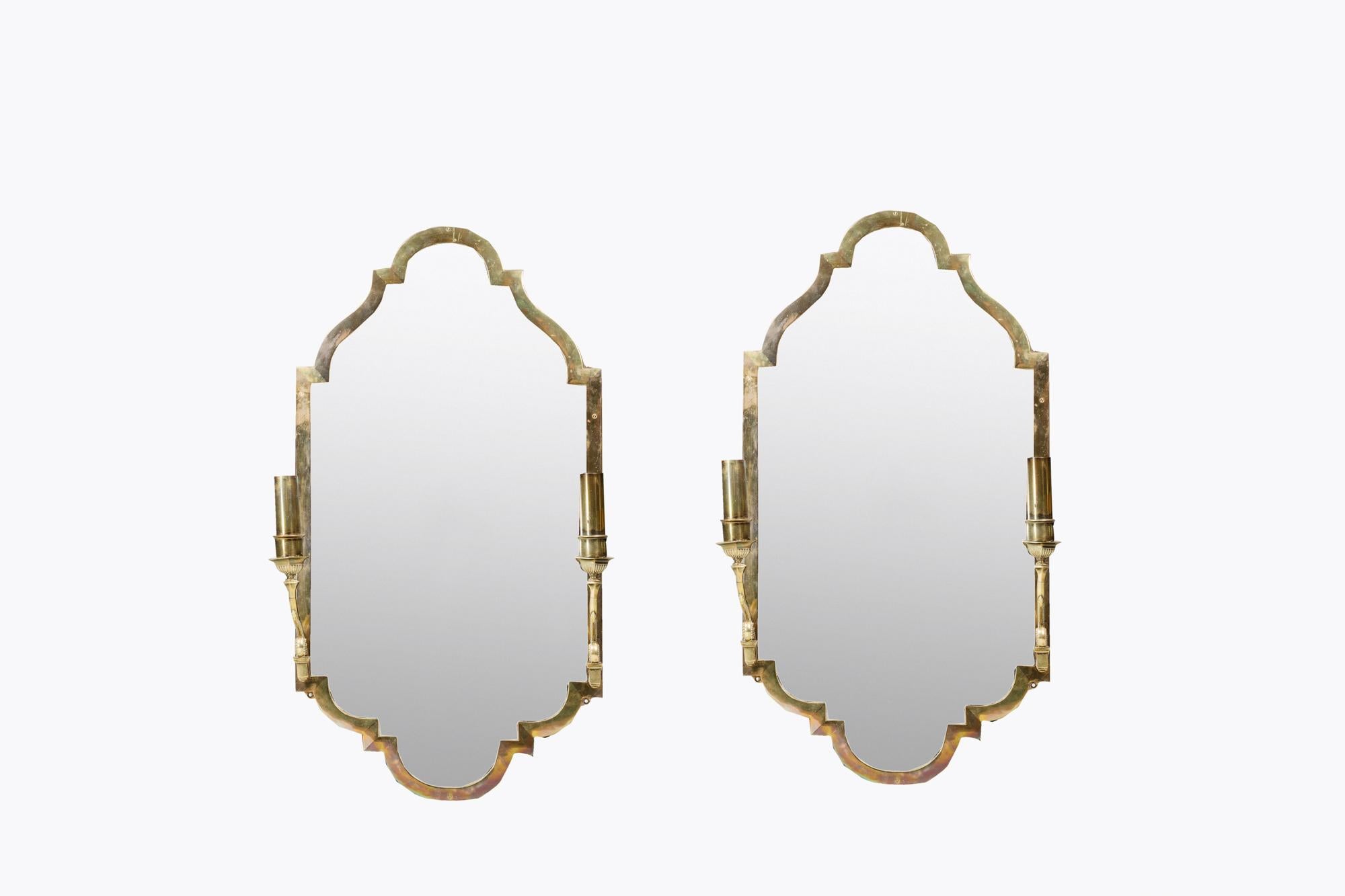 19th Century pair girandole mirrors with bevelled glass and brass frames with arched tops and bases. Each with a pair of scroll stemmed candle holders.