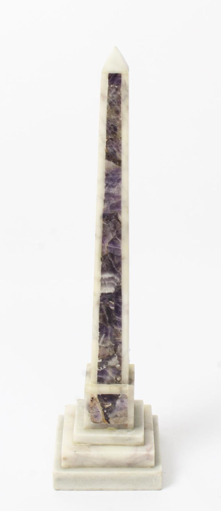 A stunning antique pair of Carrara and amethyst marble 'Grand Tour' obelisks dating from the late 19th century.

The pair are carved from the finest Carrara marble with amethyst panels on tapering bodies raised on square stepped marble