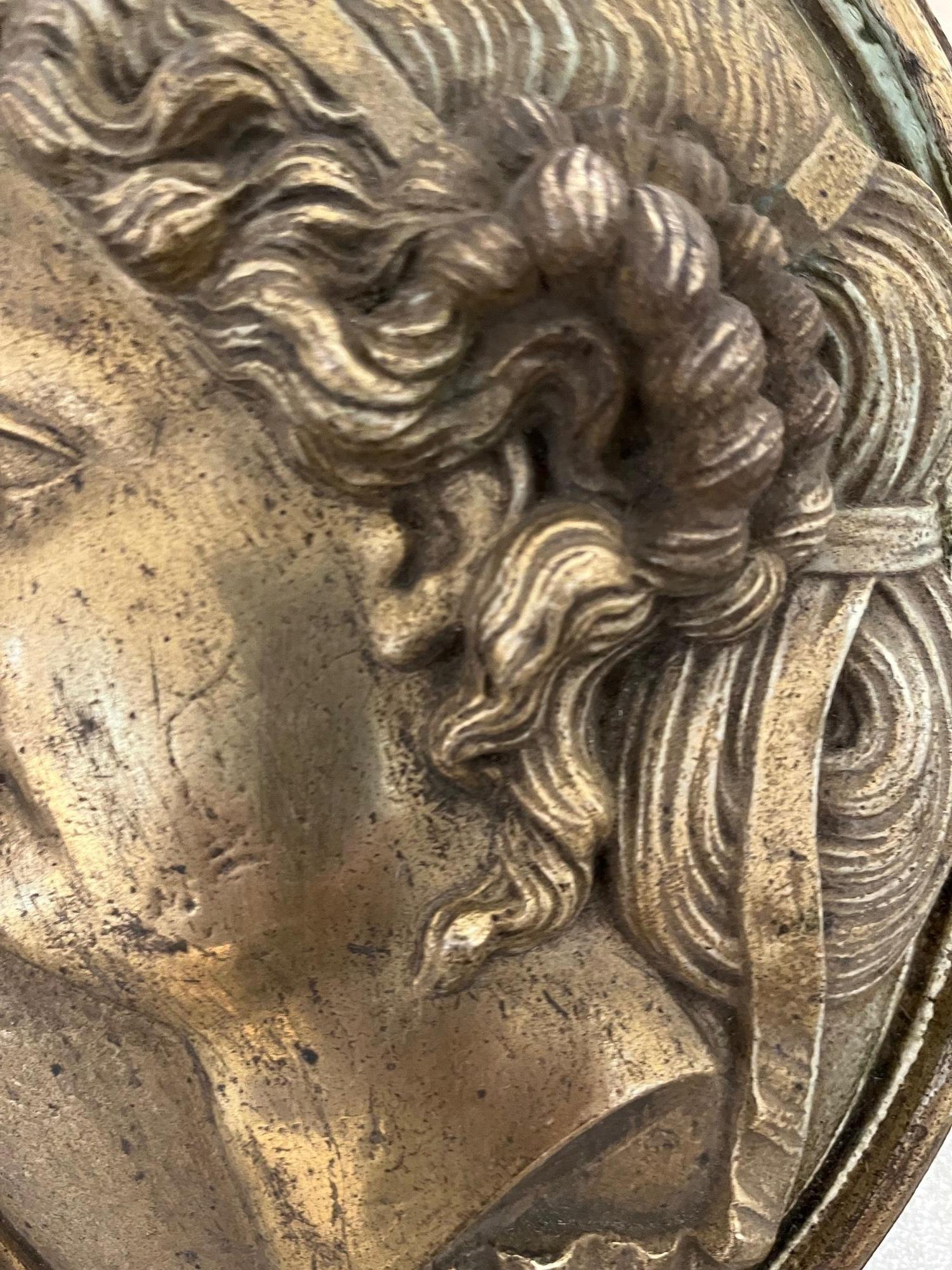 Elegant pair of Grand Tour oval gilt metal medallions featuring finely detailed classical profiles — one male and one female — in high relief. Executed with refined modeling characteristic of late 19th century neoclassical and academic taste.

The