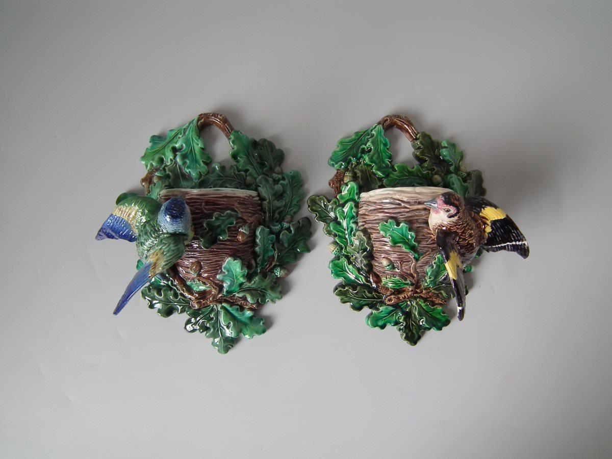 Lonitz Majolica wall pocket which features a goldfinch on one side and another finch on the other, attending their nests, surrounded by oak leaves and acorns. Colouration: green, brown, ochre, are predominant. The piece bears maker's marks for the