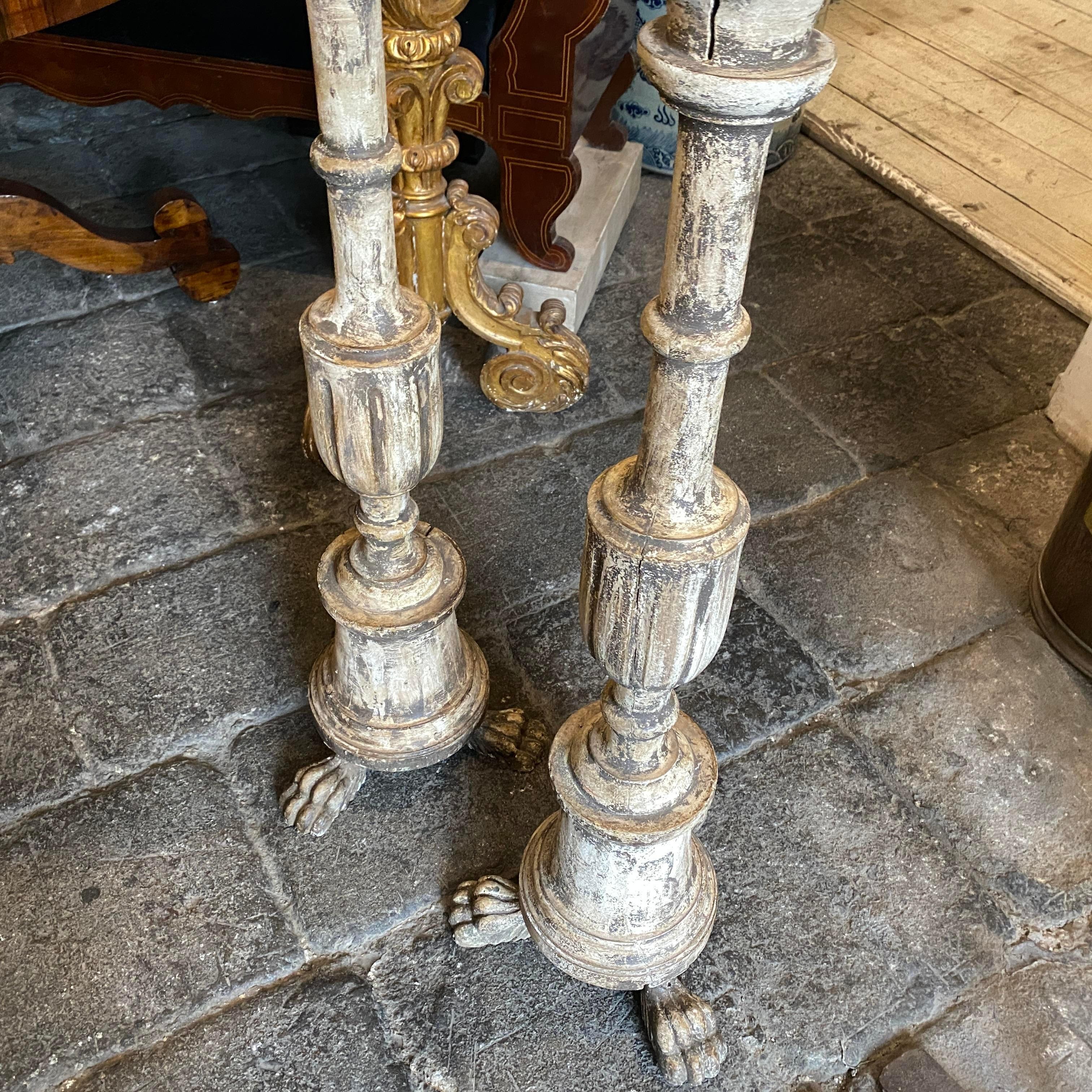 Two hand-carved wood candle holders made in Italy in the second half of 19th century, they have lion paws and an amazing old white and gray original patina. They have real signs of use and age visible on the photos. they came from an old private