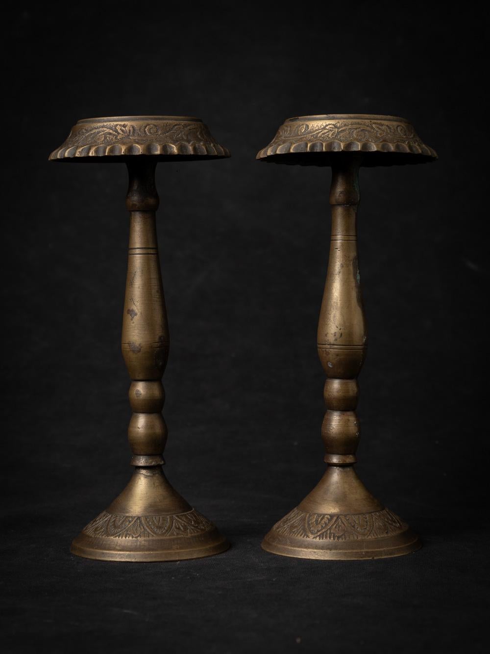 Certainly, here's a more detailed description:

This exquisite pair of antique Candle Holders from 19th-century India showcases the enduring beauty of traditional craftsmanship. Handcrafted from bronze, a material renowned for its durability and