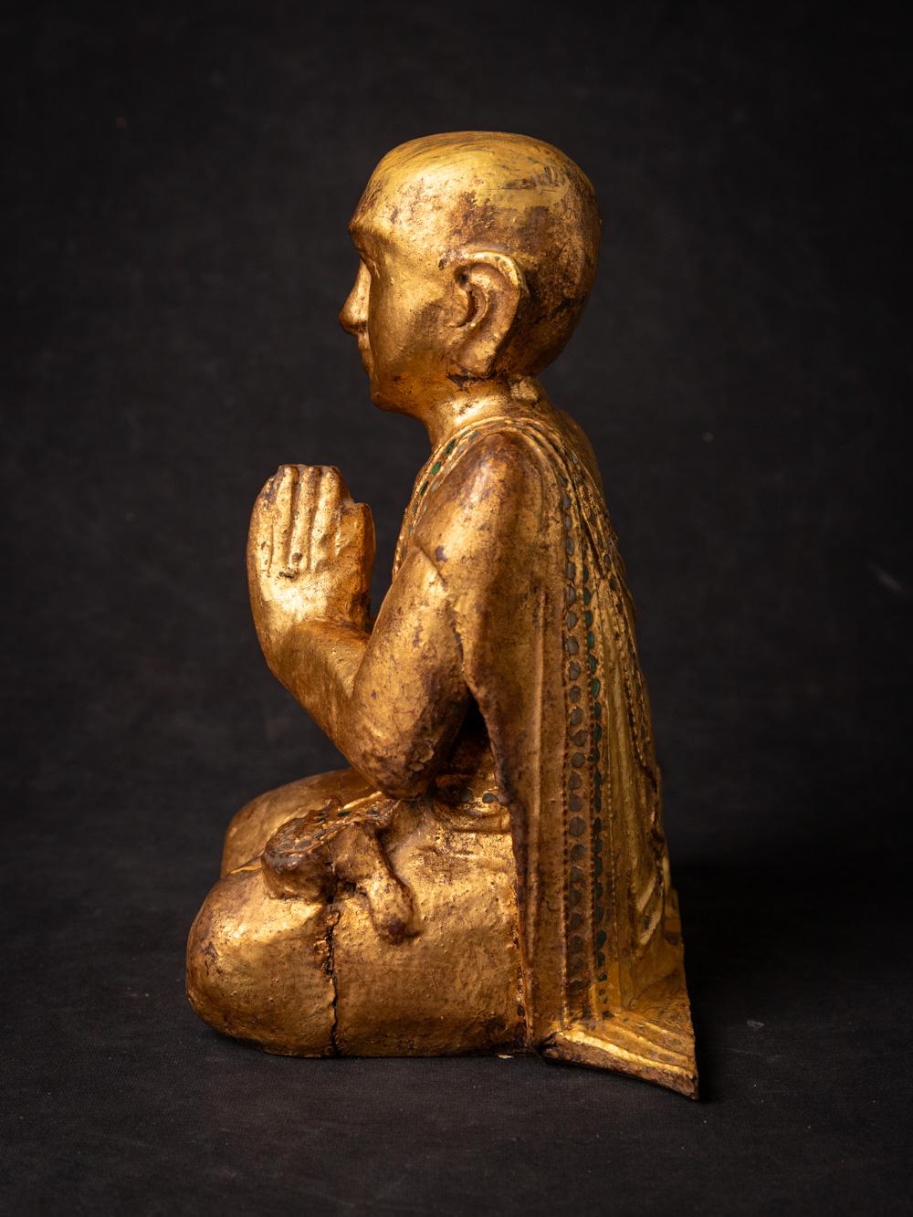 The Antique wooden Burmese Monk statue is a remarkable and spiritually significant artifact originating from Burma. Crafted from wood and gilded with 24-karat gold, each statue stands at 23.5 cm in height and measures 19.7 cm in width and 13.3 cm in