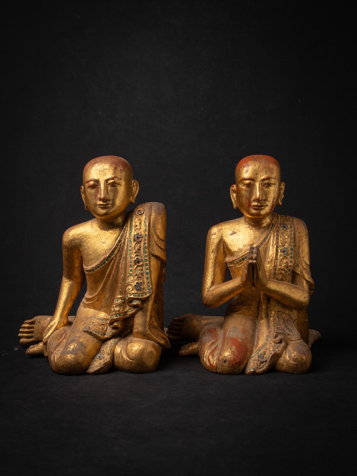 This exquisite pair of antique wooden Burmese monk statues, originating from Burma (modern-day Myanmar) and crafted in the renowned Mandalay style, showcases exceptional artistry and devotion. Carved from wood and standing 31 cm high, each statue