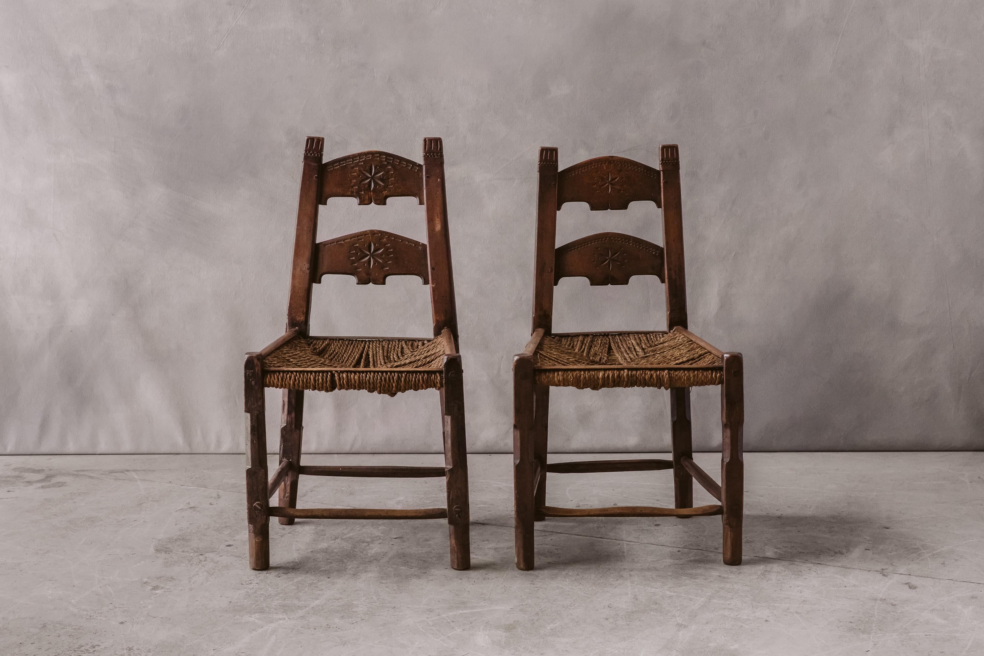 Early pair of Art Populaire chairs from France, Circa 1880. Solid pine construction with original rope seats. 


 