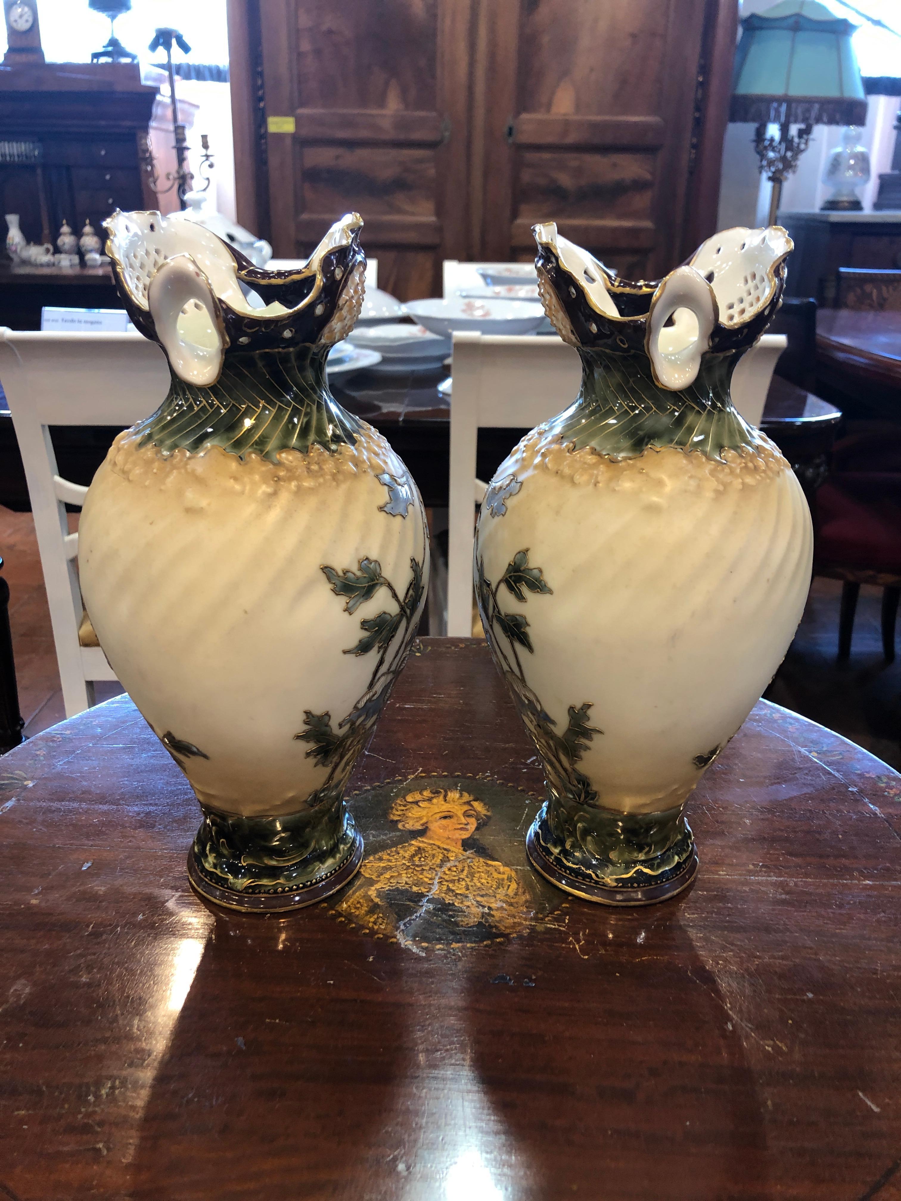 Pair of Austrian Pitchers signed EV Turn Vienna, circa 1880. In porcelain and painted with floral motifs, some parts of the flowers are in relief. The author is Ernst Wahliss from Vienna. His Vienna store was established in 1863. His business was so