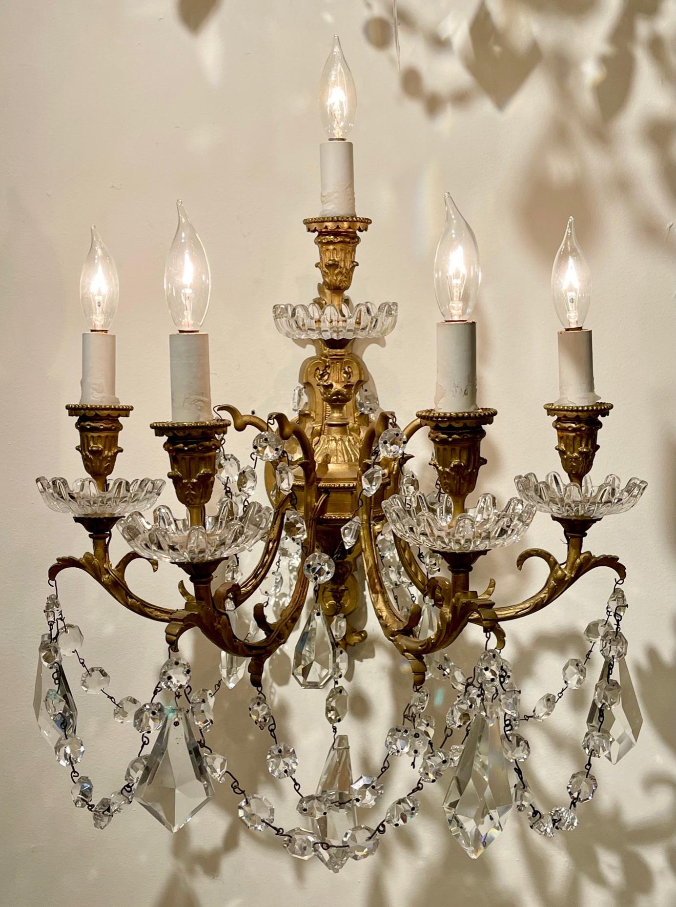 Exceptional pair of 19th century Baccarat crystal sconces with 4 lights. Beautiful draping crystals along with a gorgeous decorative gilt bronze base. Very fine quality!