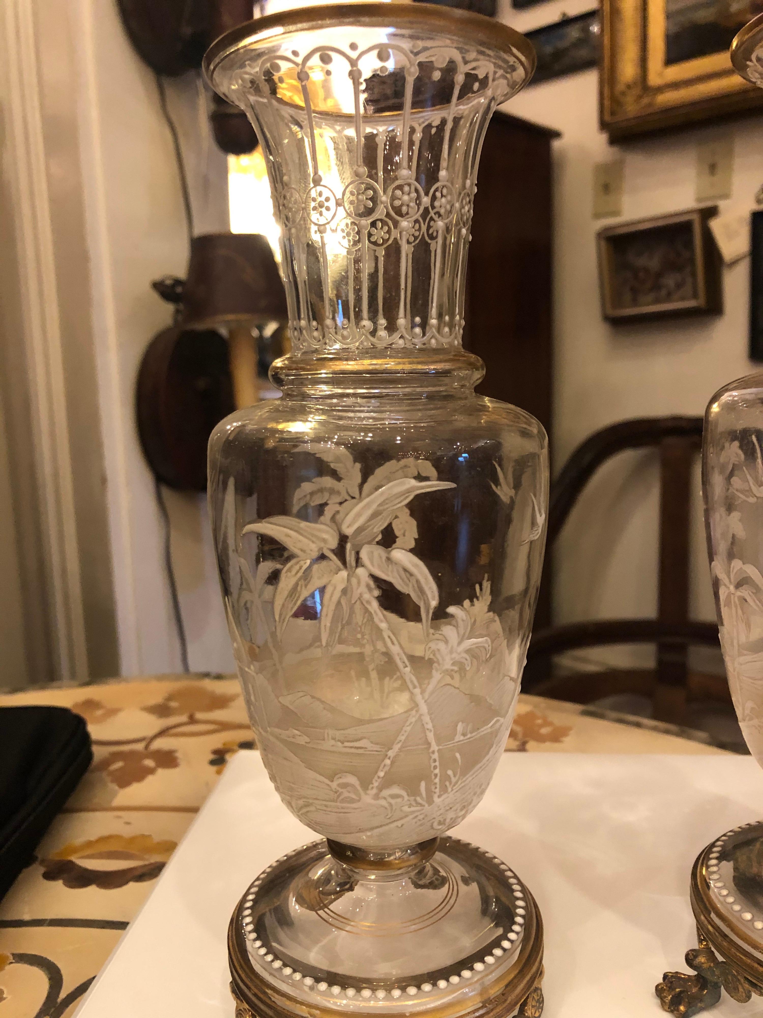 Pair of gilt bronze mounted Baccarat crystal vases with enamel decoration in white.
     