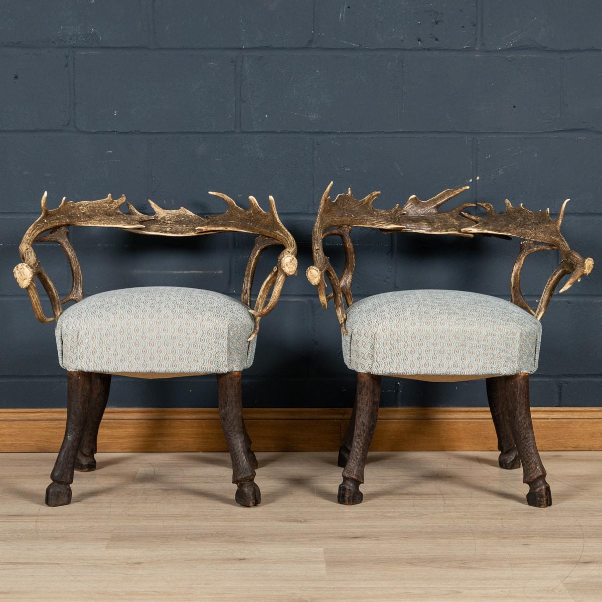 A very unusual pair of hall chairs or side chairs made in the Black Forest region of south-west Germany bordering Switzerland. The horns are intertwined and finished with carvings of Black Forest creatures to the ends, whilst the legs have been