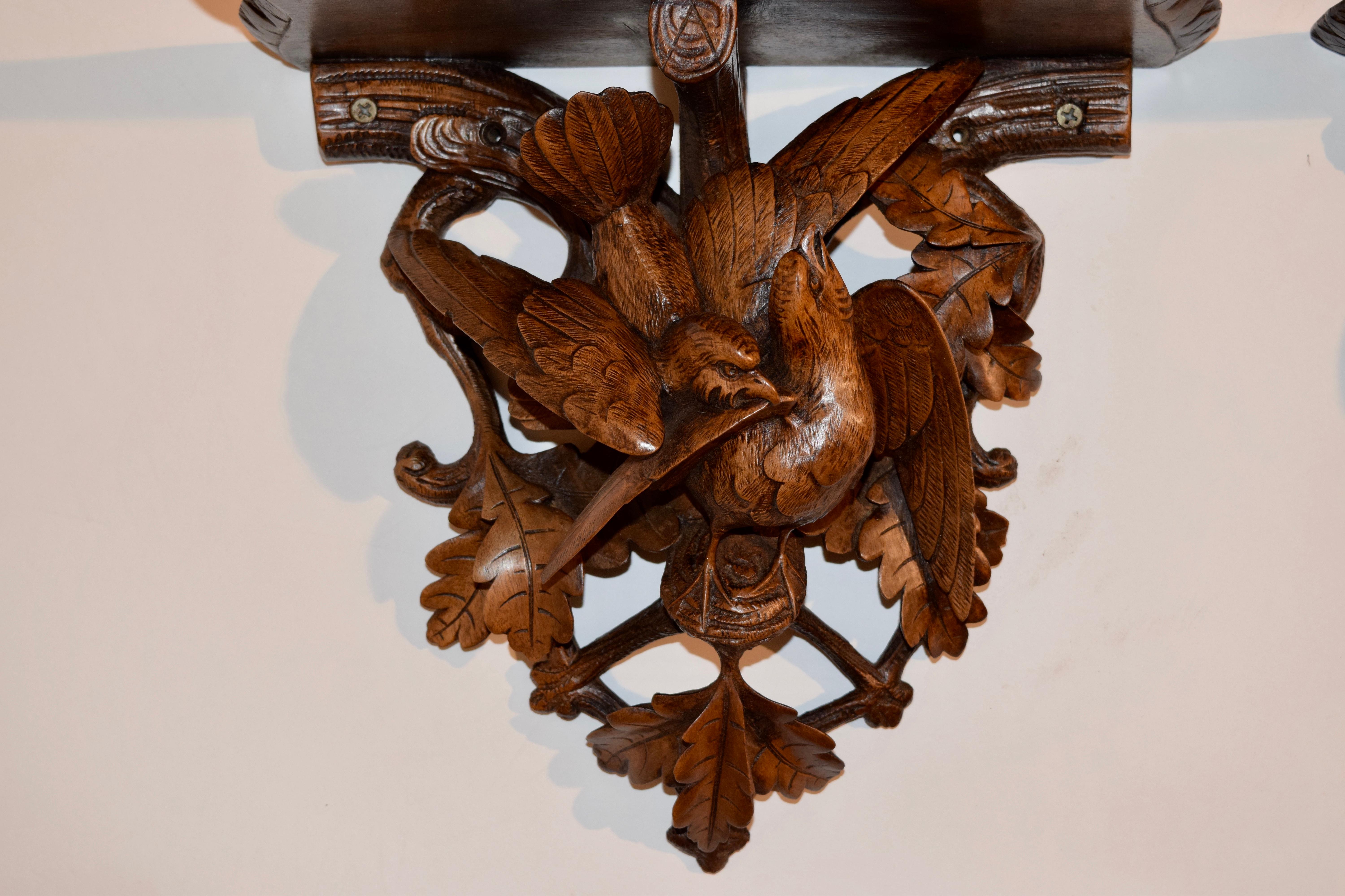 Pair of 19th century hand carved bracket shelves from the Black Forest region of Europe. The shelves have beveled edges which are hand carved decorated over wonderfully depicted hand carved birds on branches protecting their nests. Wonderfully hand