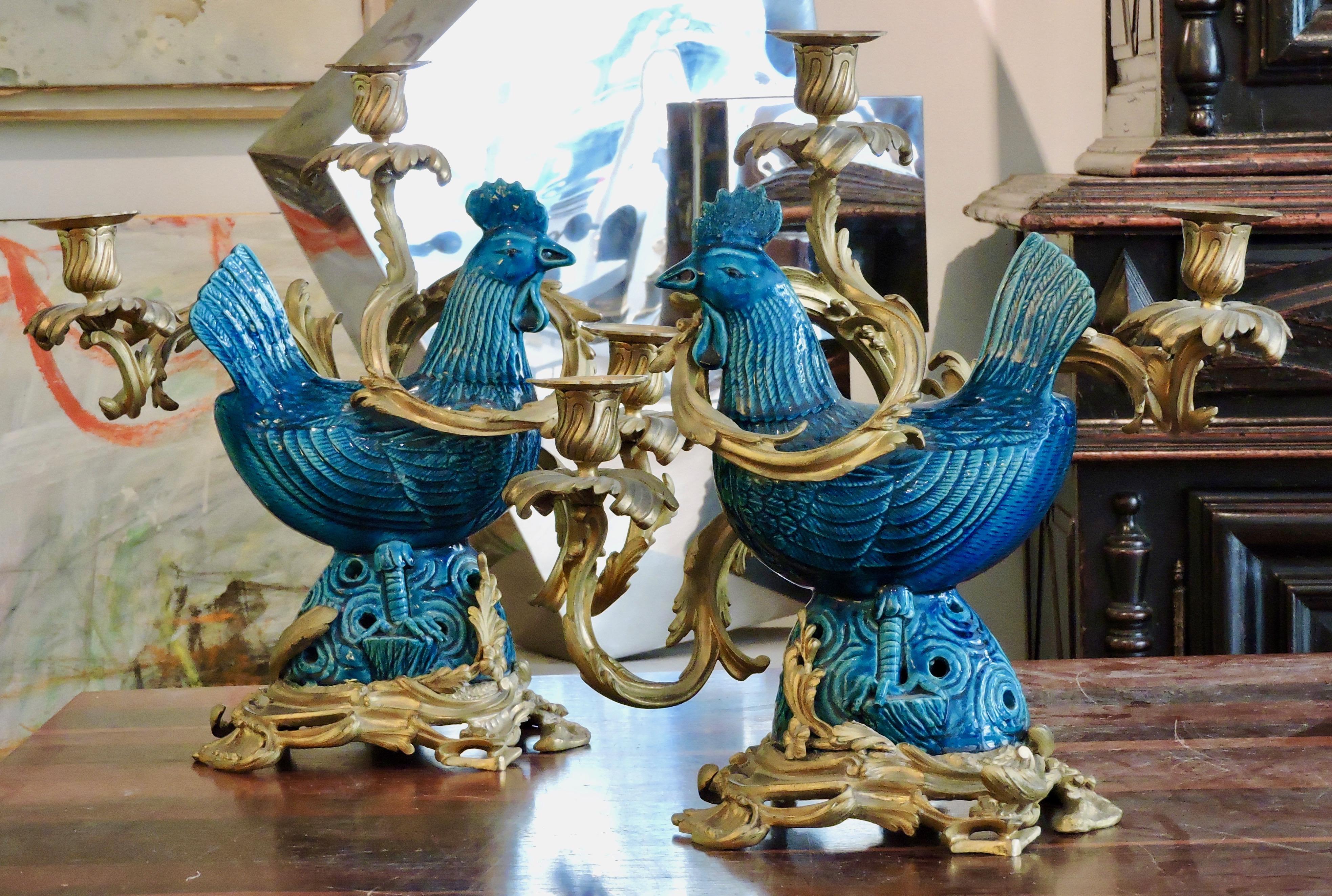 A 19th century pair of turquoise blue enameled faience roosters ormolu-mounted three lights candelabras.
Louis XV style
circa 1880
Fitted for electricity.