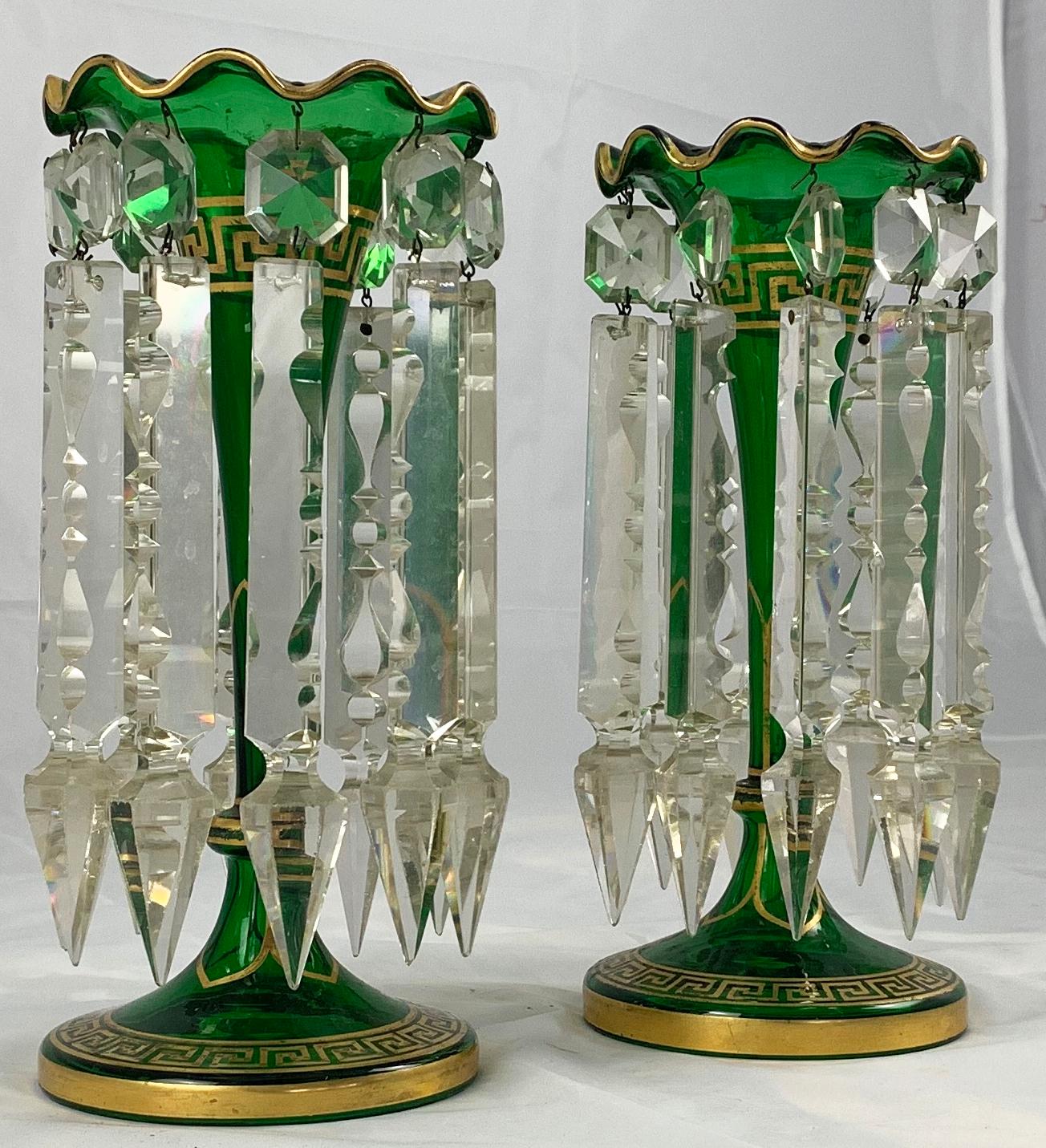 A fine pair of Bohemian green crystal lustres. 
19th century. 

With faceted drops. Gilt decoration throughout. Each on a short stem and circular base.