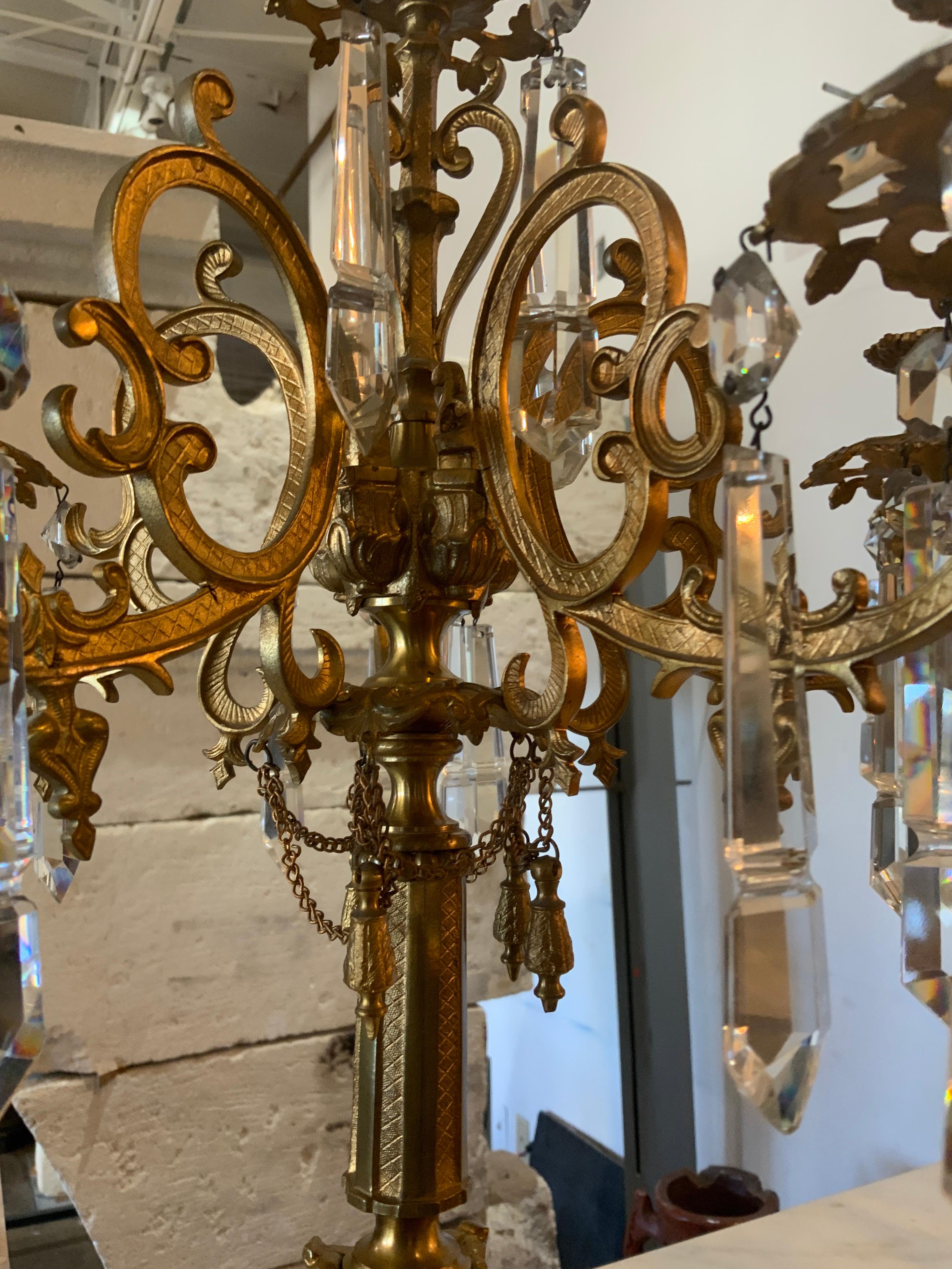 These bronze candlesticks feature chandelier crystals along each side. Perfect accent pieces for a mantel. Origin; France.