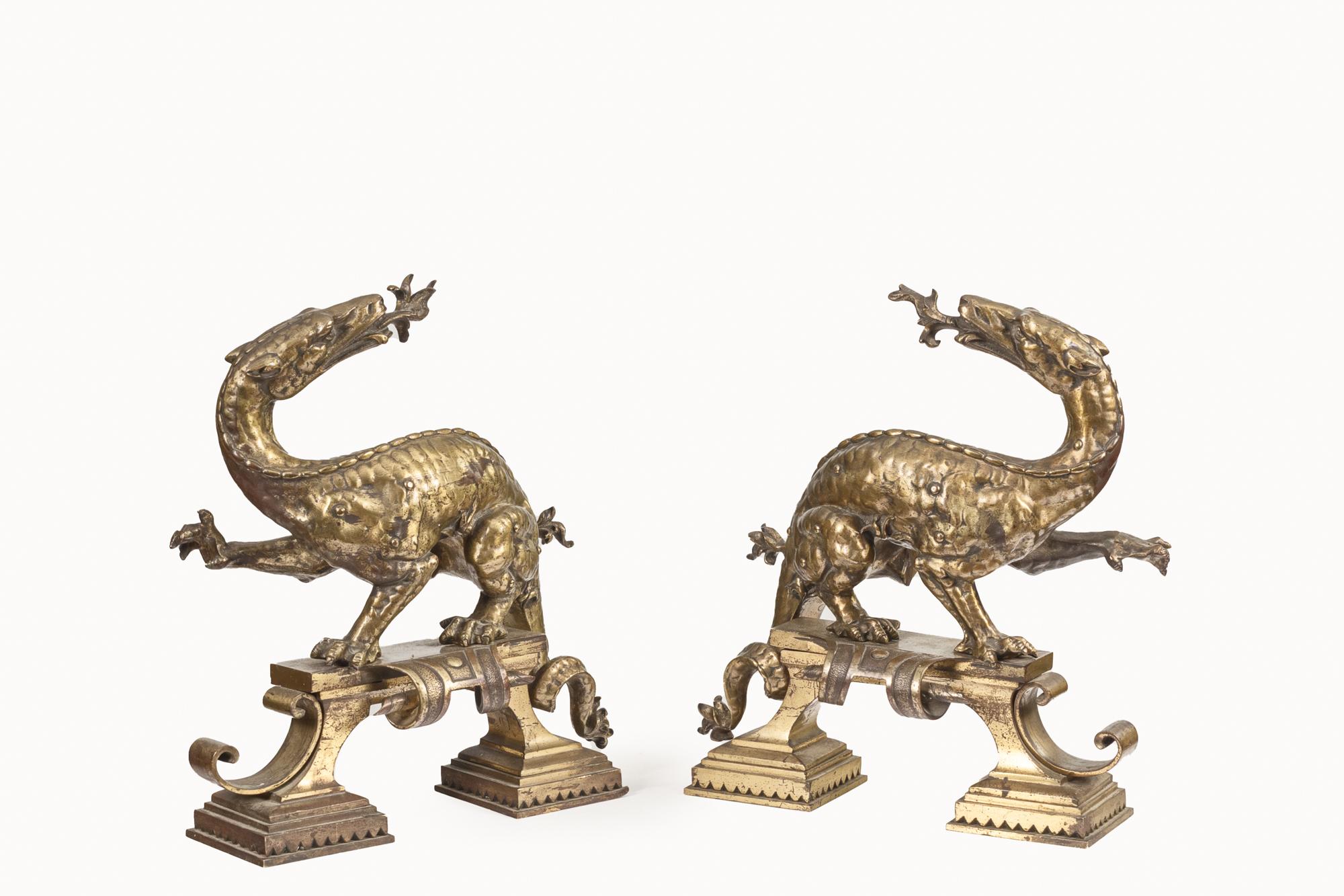 19th Century pair of bronze Scottish dragon iron dogs stood on scrolling plinths.
