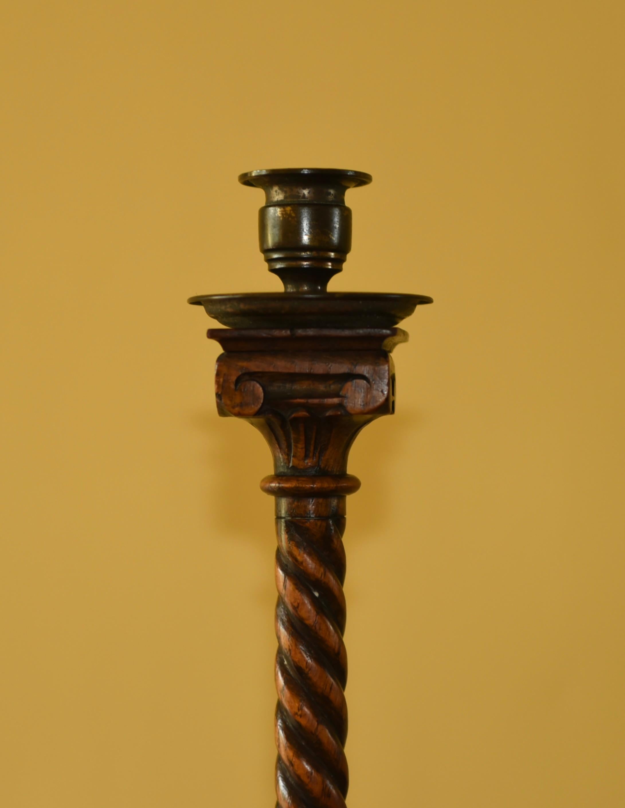 unusual pair of carved oak candle sticks in the Corinthian column form circa 1890
very well hand carved with brass candle mounts .
both in very good condition .11 inches tall 
