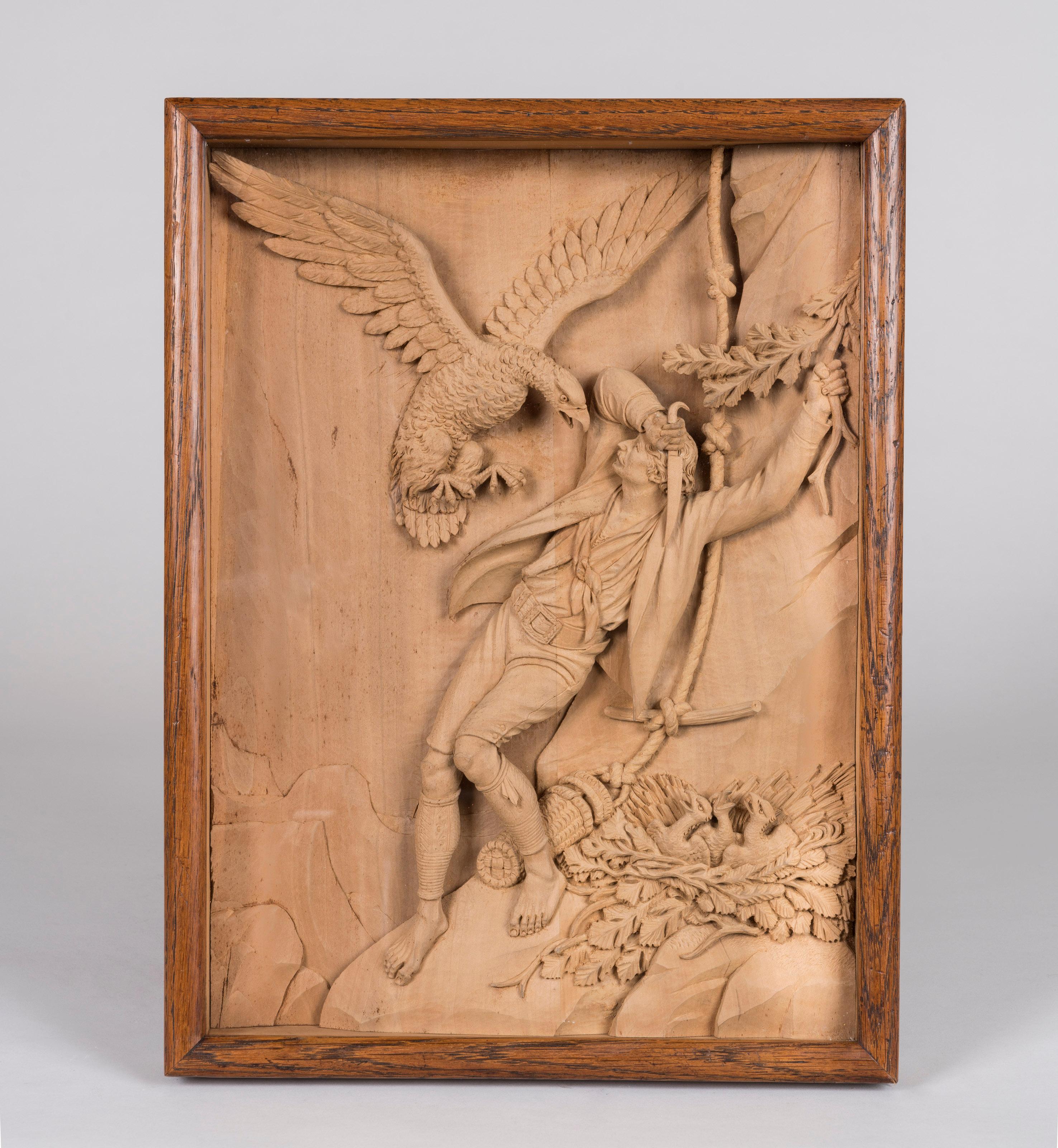 A pair of carved limewood shadow boxes

Finely carved in high relief, and depicting two famous scenes of an eagle attacking a man, and a poacher being shot, housed within rectangular oak frames. Bearing the paper label of the framer, and the