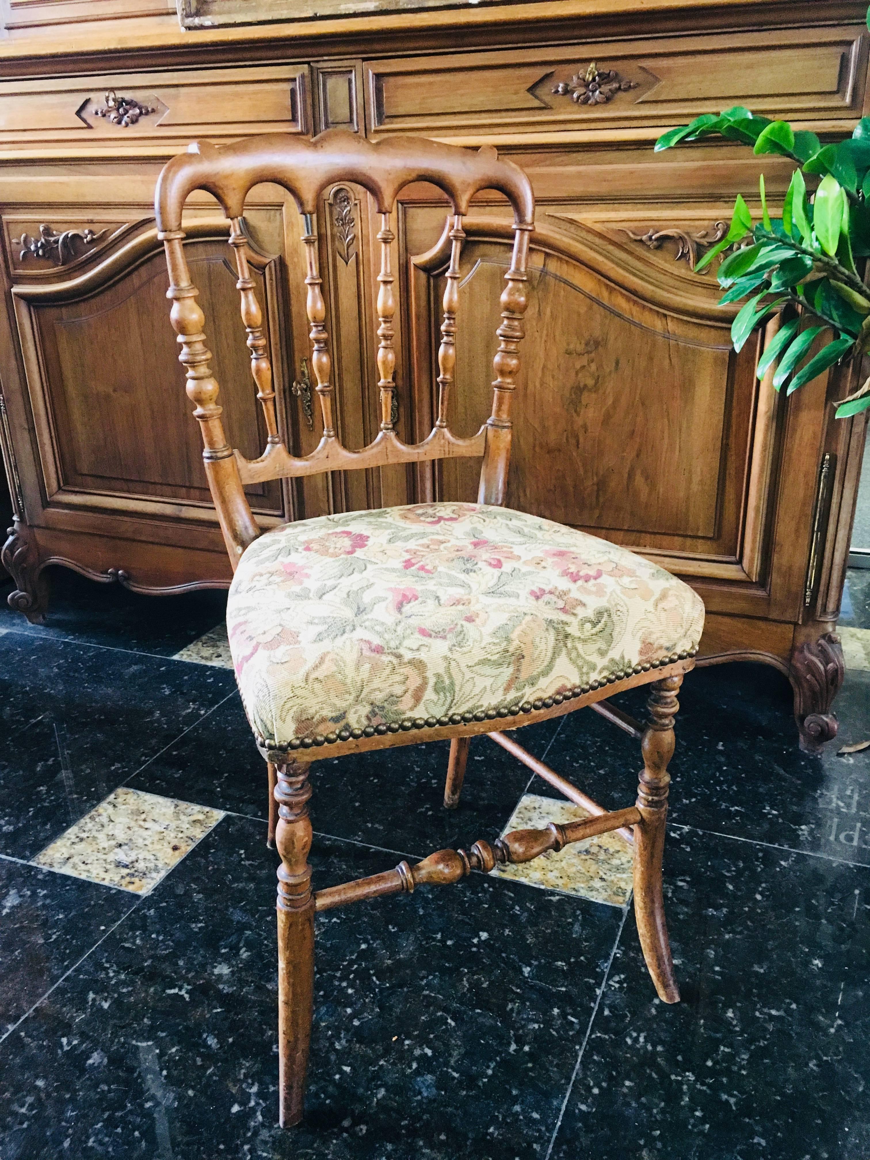 19th century pair of carved walnut chairs from France. Very stable and comfortable with floral upholstery,
circa 1860.