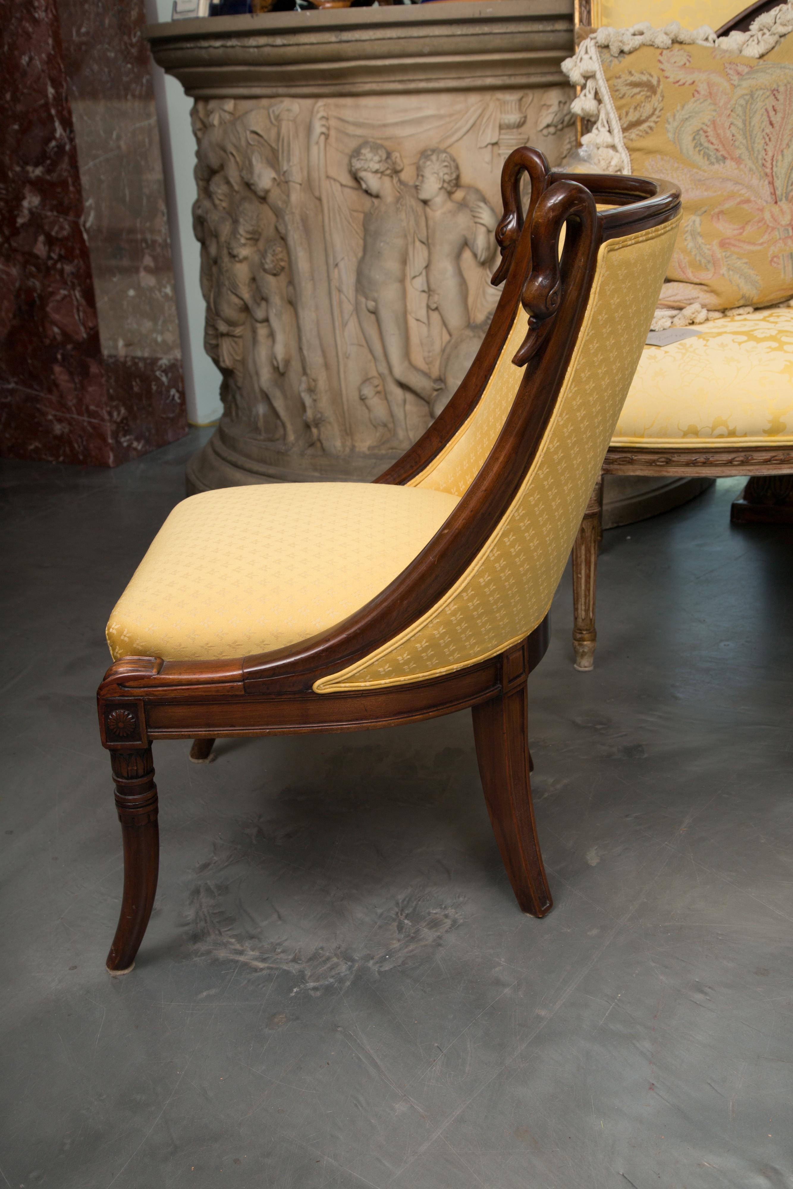 This is a charming set of mahogany French Directoire children’s chairs. The chairs have sloping side rails terminating in swans’ heads framing a fully upholstered seat and back, supported by slightly splayed legs, 19th century.