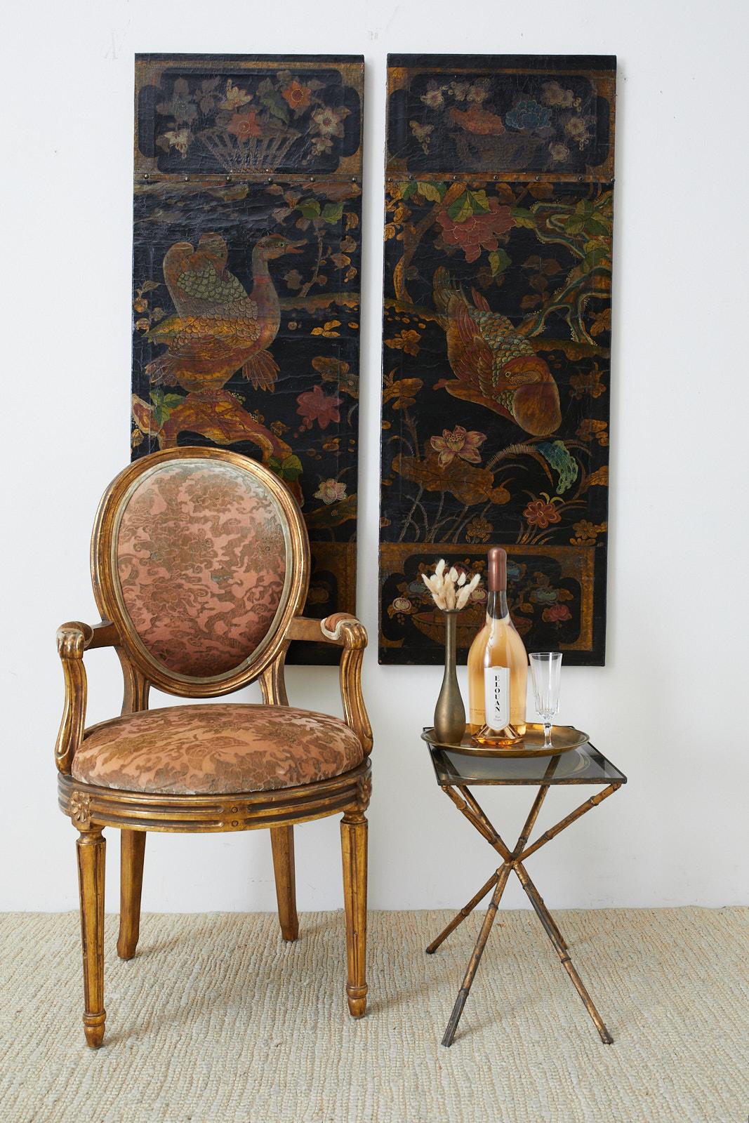 Amazing pair of Chinese polychrome decorated leather panels featuring Koi fish and ducks among beautifully painted flowers and foliage. 19th century frames of wood covered with skin and lacquered with an aged patina and craquelure finish. The tops