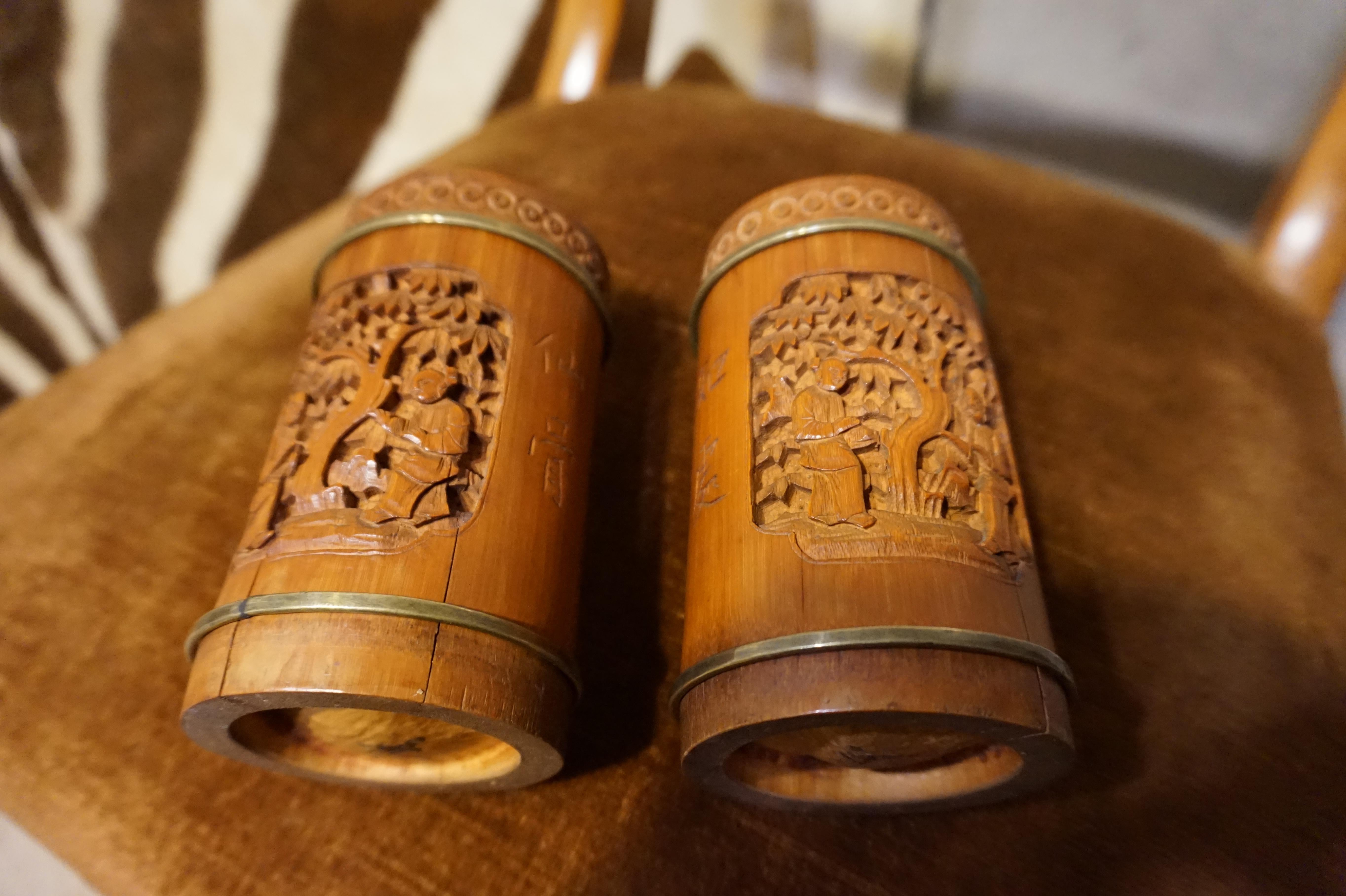 Hand carved intricate Chinese scholar's bamboo brush pots with brass rings and script. Original warm patina and some cracks as photographed present, circa 1880s.
 
  