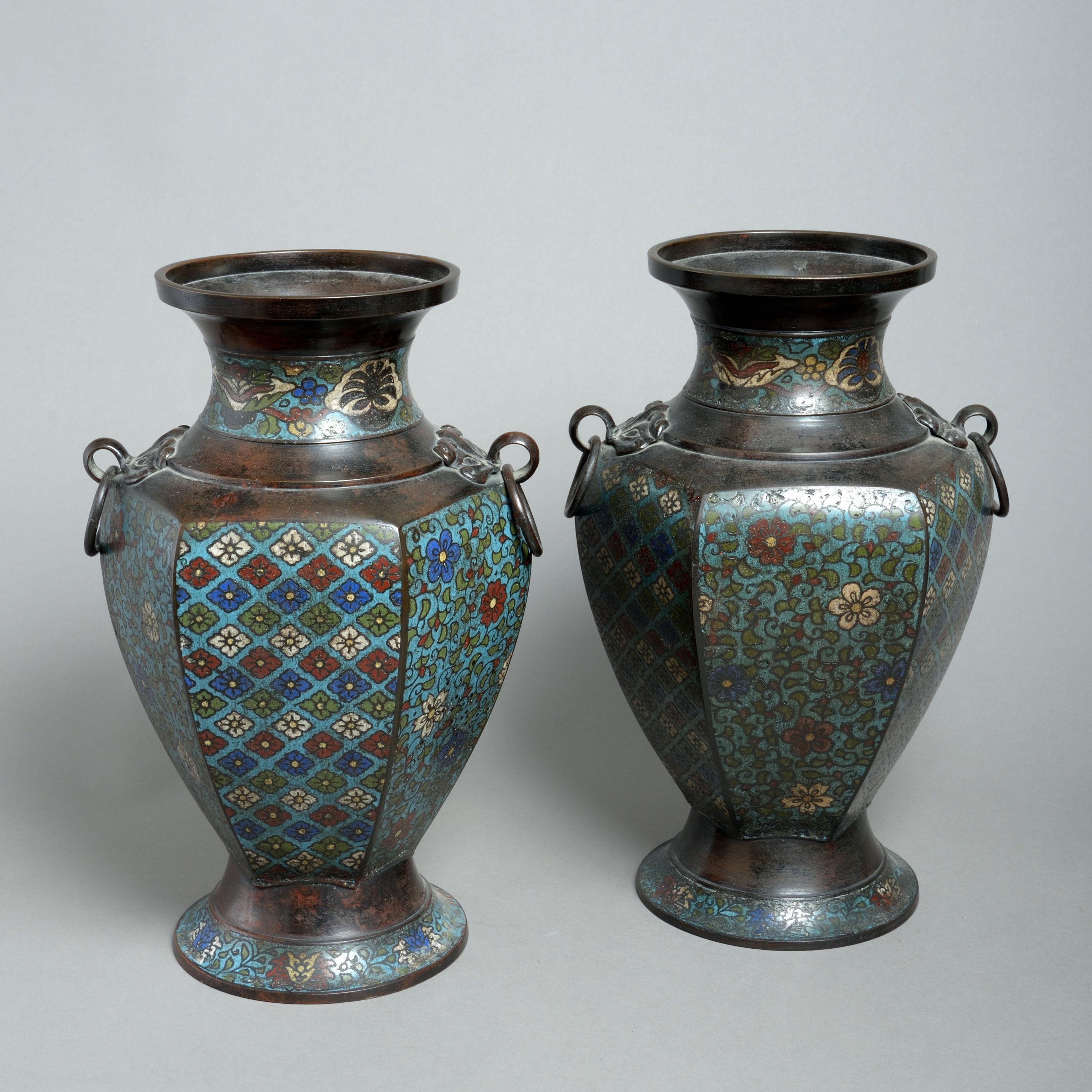 A pair of 19th century cloionné enamel vases, of faceted baluster form, with polychrome geometric decoration.
 