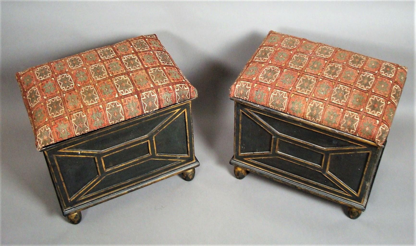 Unusual 19th century pair of decorated box stools with original black and gilt painted decoration; the padded rectangular seats/lids upholstered in old patterned carpert, opening to reveal and old paper lined storage compartment. The panelled sides